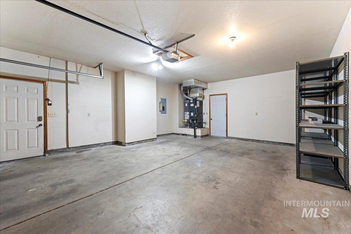 Garage with electric panel and a garage door opener