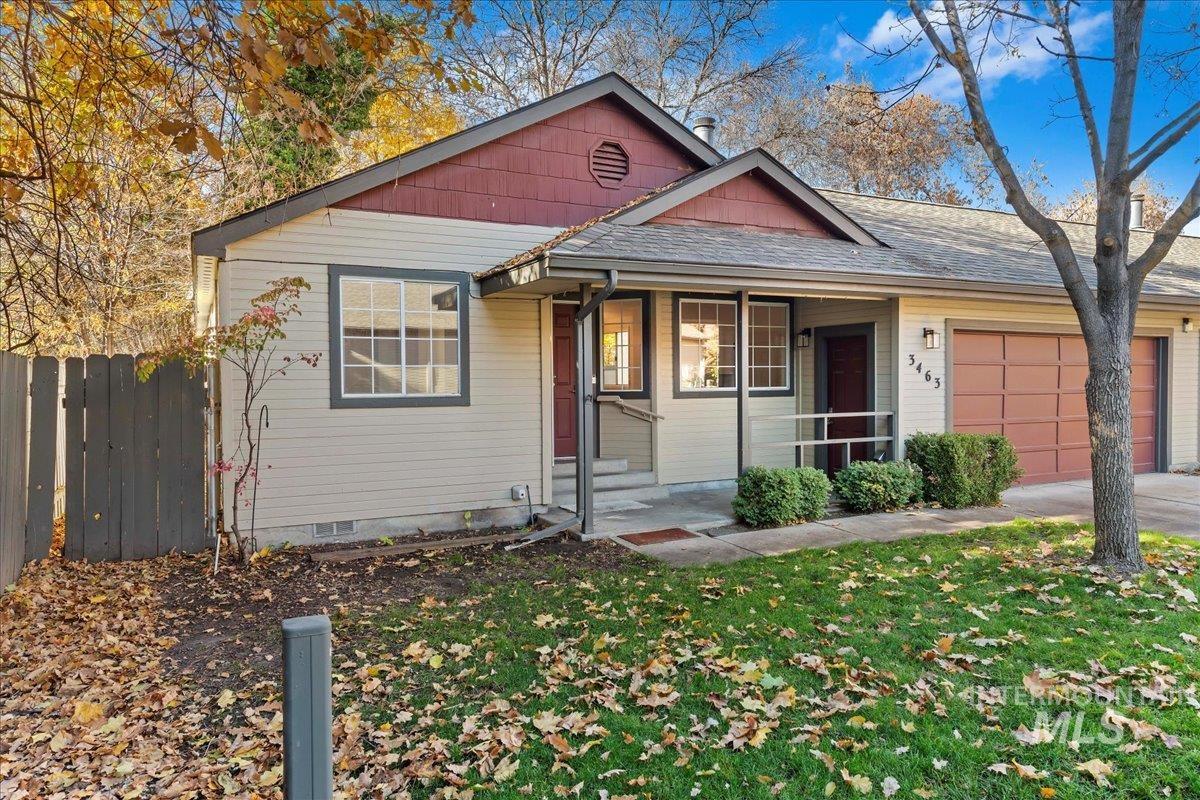 Bungalow-style home with an attached garage, roof with shingles, covered porch, and crawl space