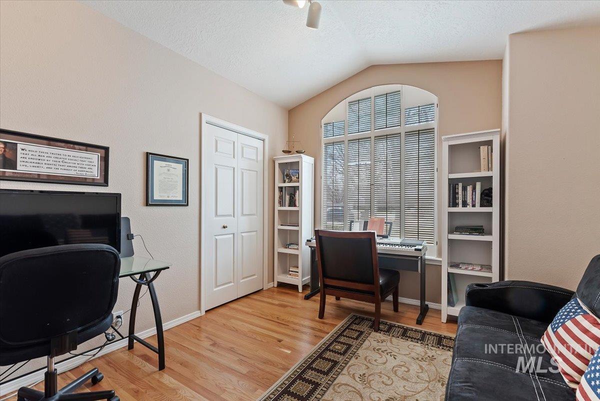 Home office featuring light wood-type flooring and ceiling fan