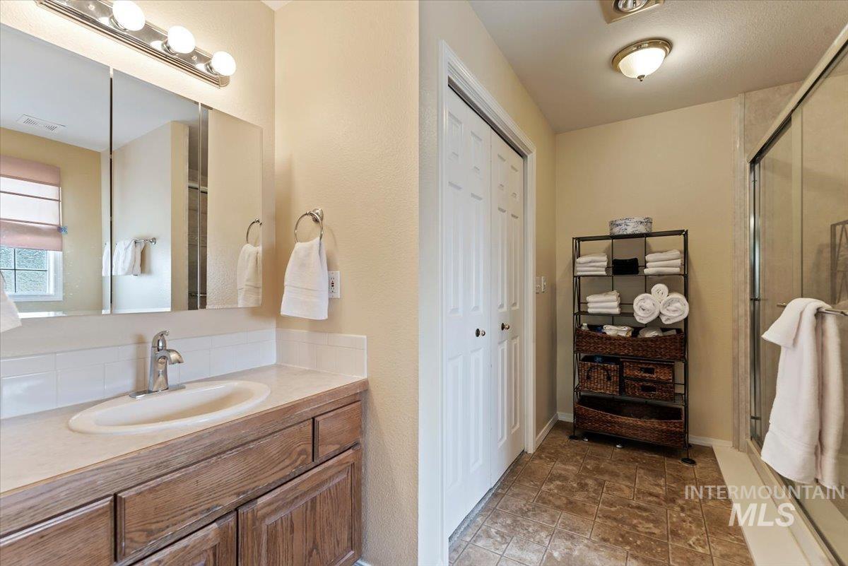 Bathroom featuring vanity and a stall shower