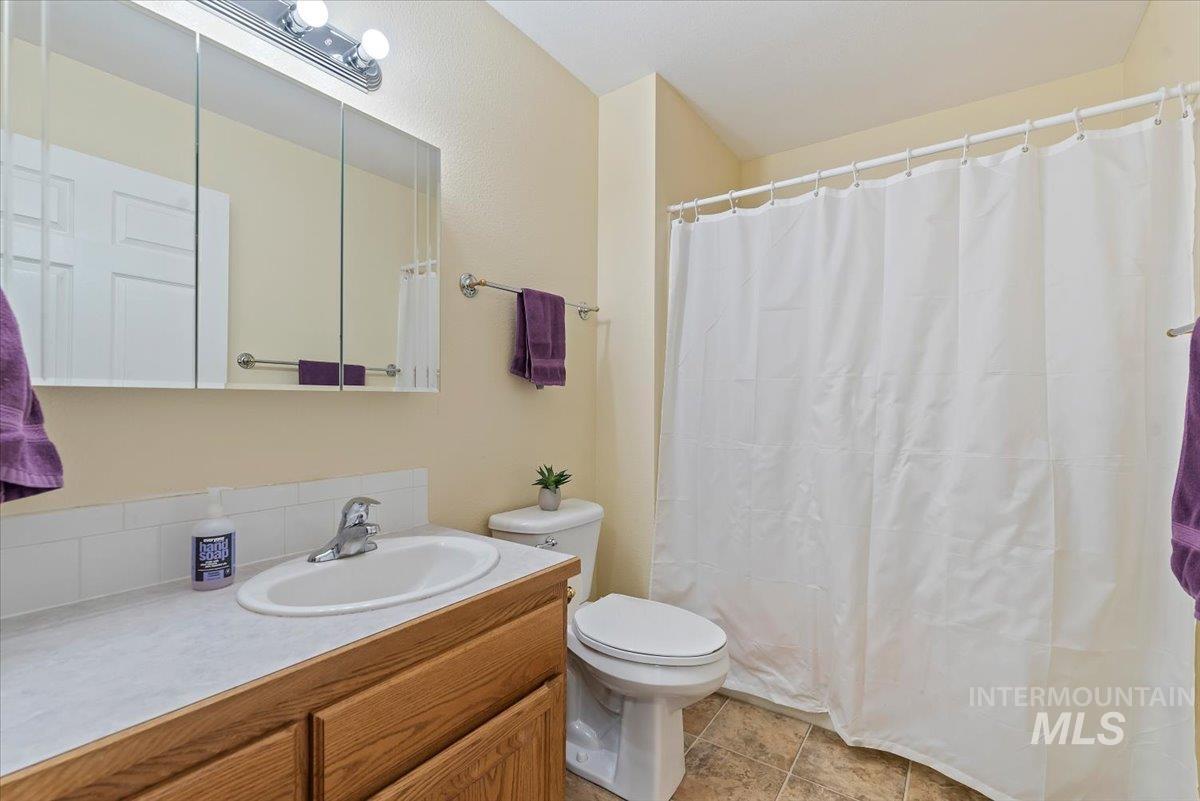 Full bath with vanity and a shower with curtain