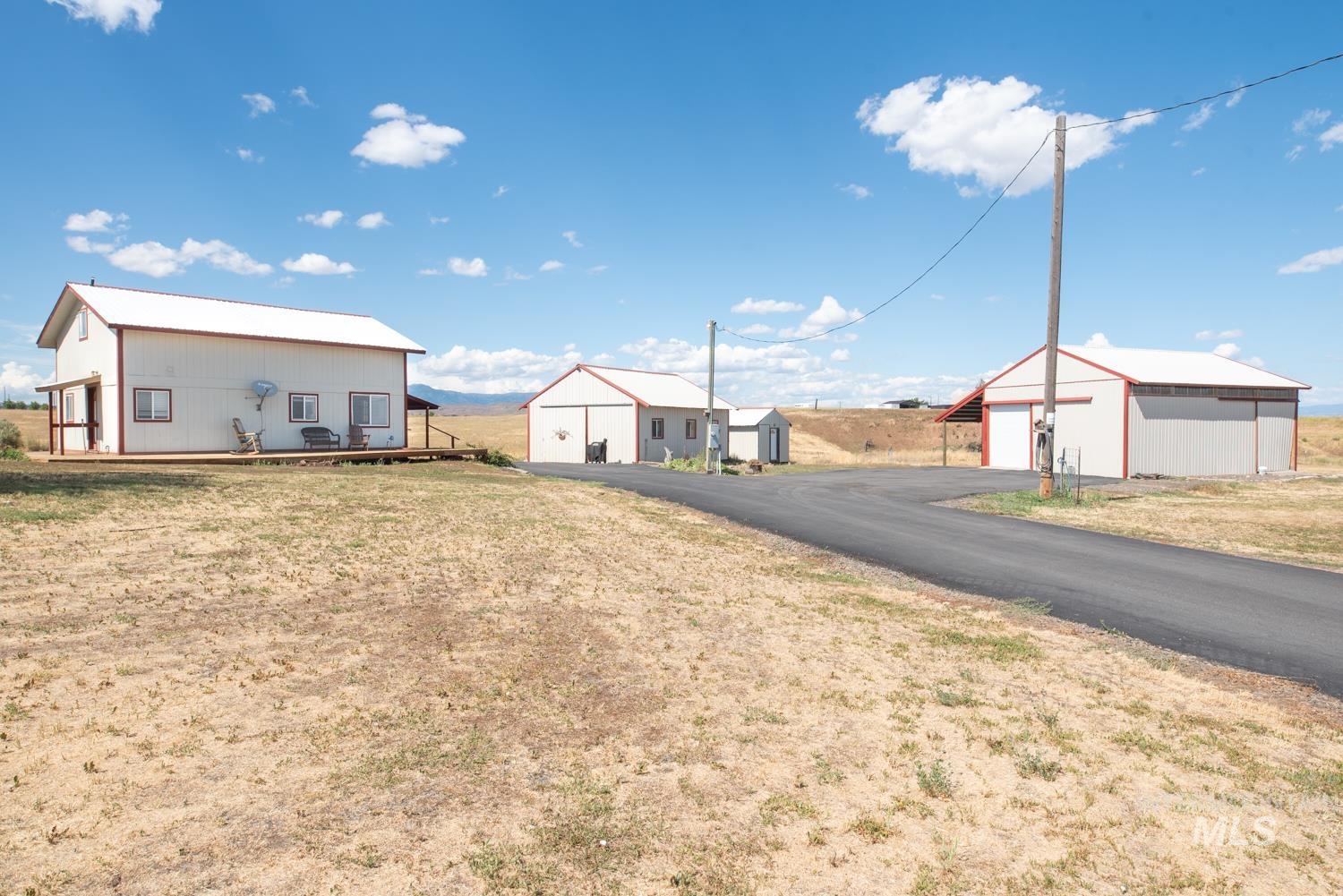 View of yard with a garage and an outbuilding