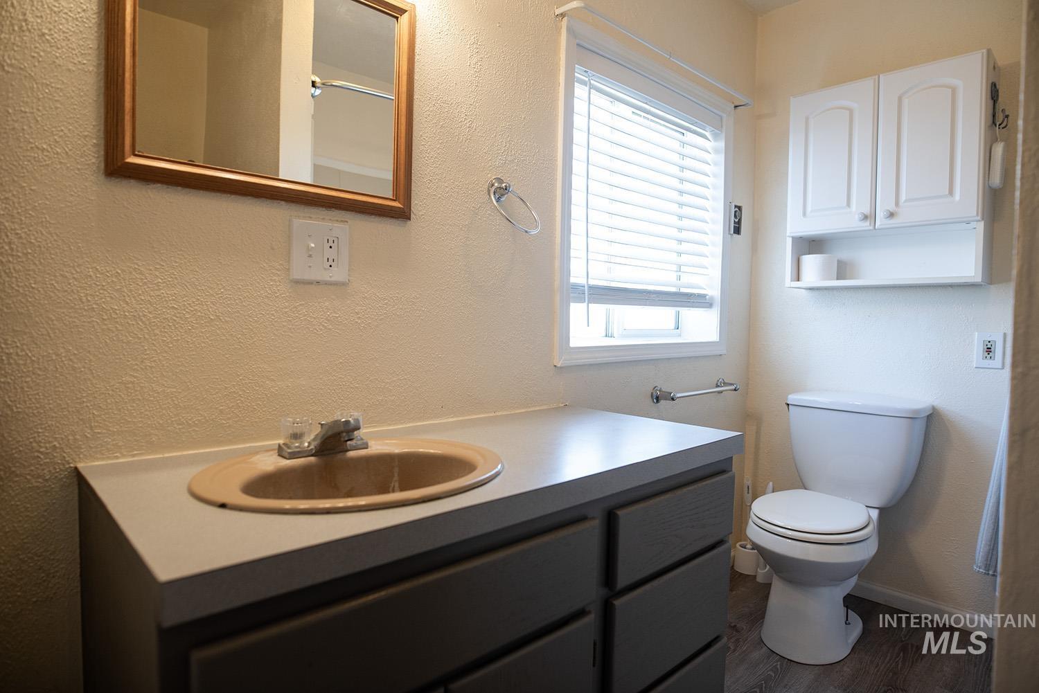 Bathroom featuring vanity and wood finished floors