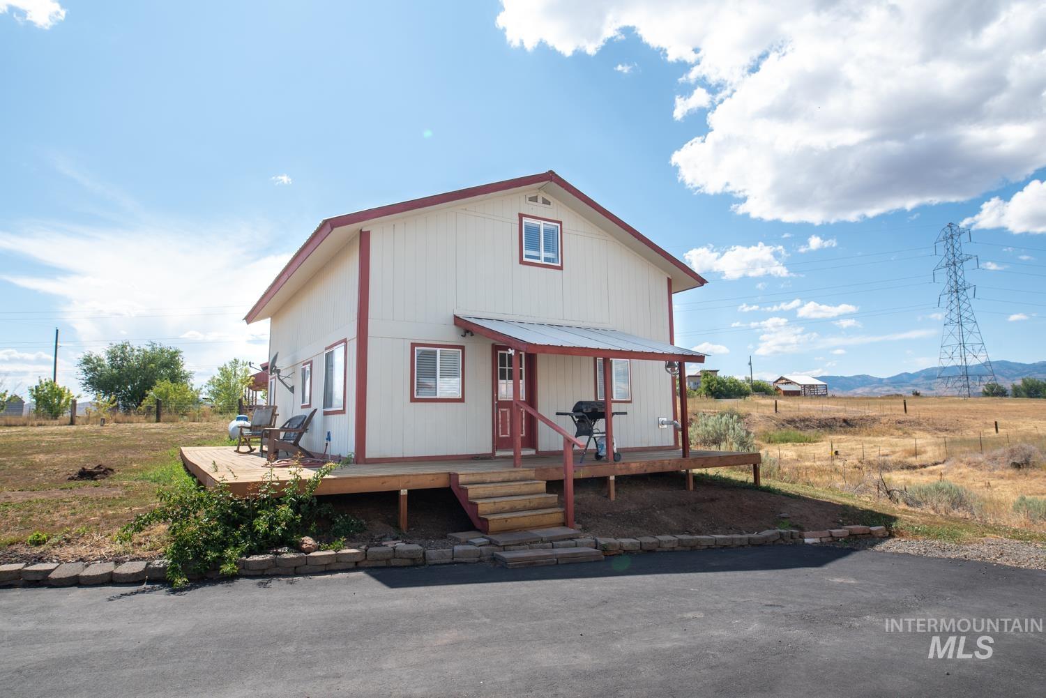 View of front of property with a wooden deck and a metal roof