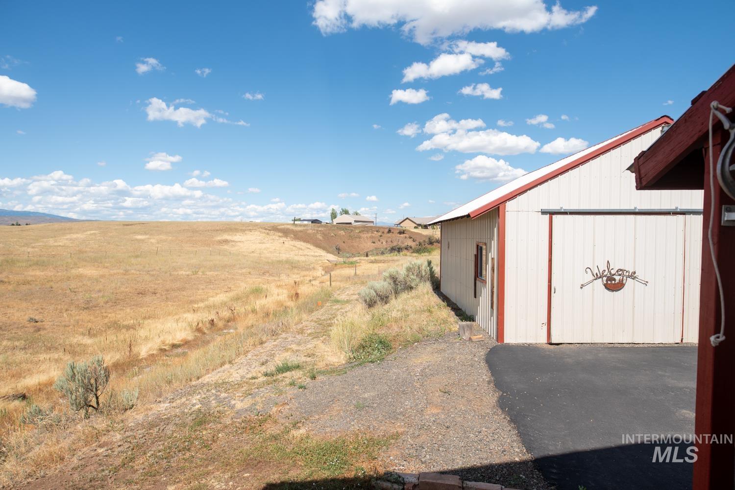 View of yard with an outbuilding and a view of countryside