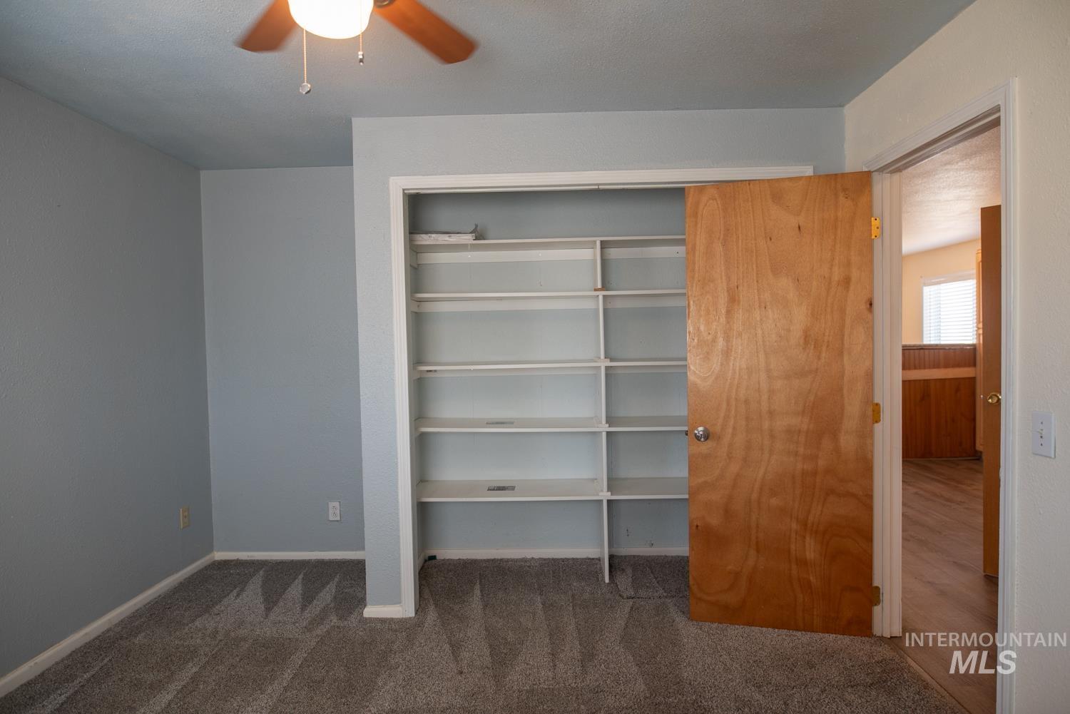 Unfurnished bedroom with carpet floors and ceiling fan