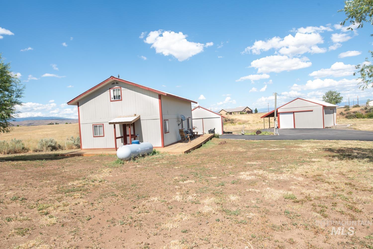 View of front of house featuring a detached garage and an outdoor structure