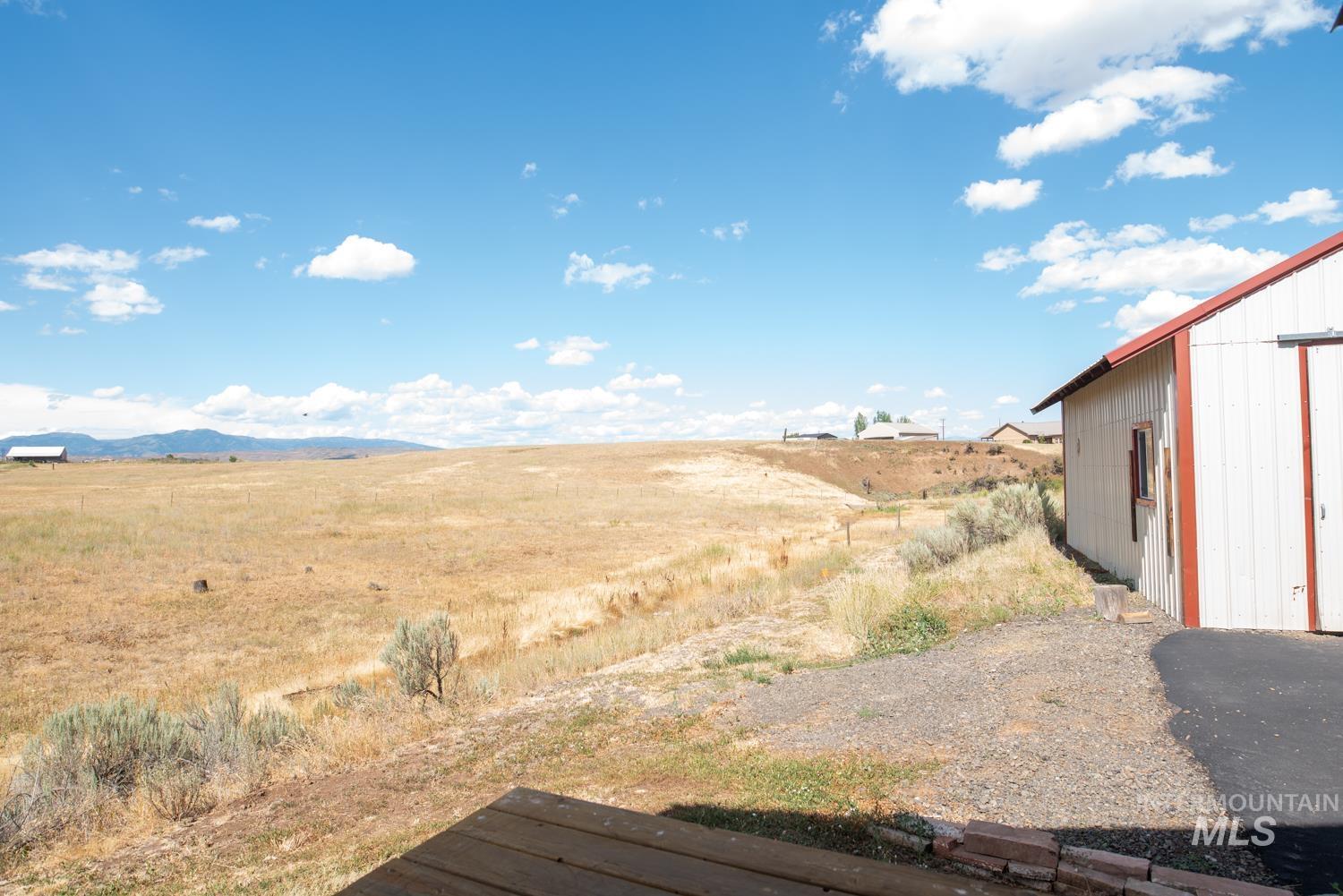 View of yard with a mountain view and a view of rural / pastoral area