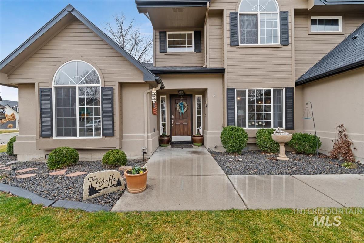 Front exterior with a multi-textured facade featuring horizontal siding and stucco finishes