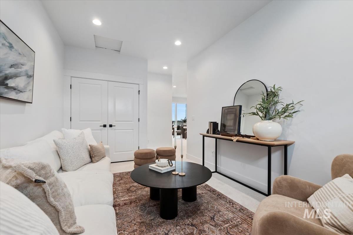 Sitting room with recessed lighting and attic access