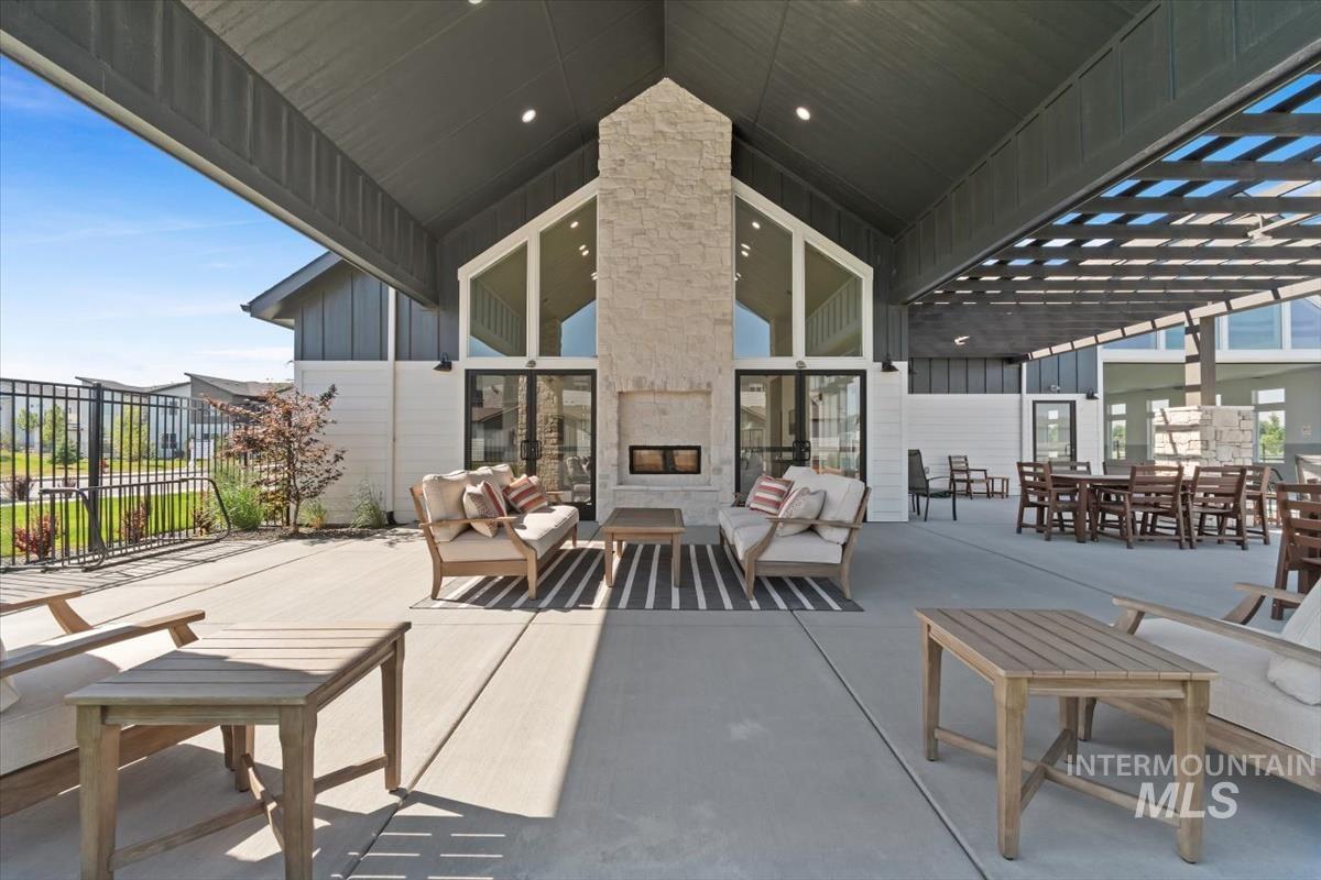 View of patio / terrace with an outdoor living space with a fireplace and outdoor dining area