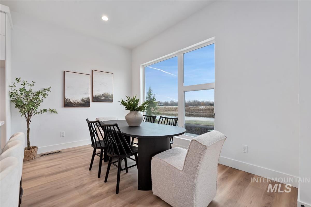 Dining area featuring light wood-type flooring and recessed lighting