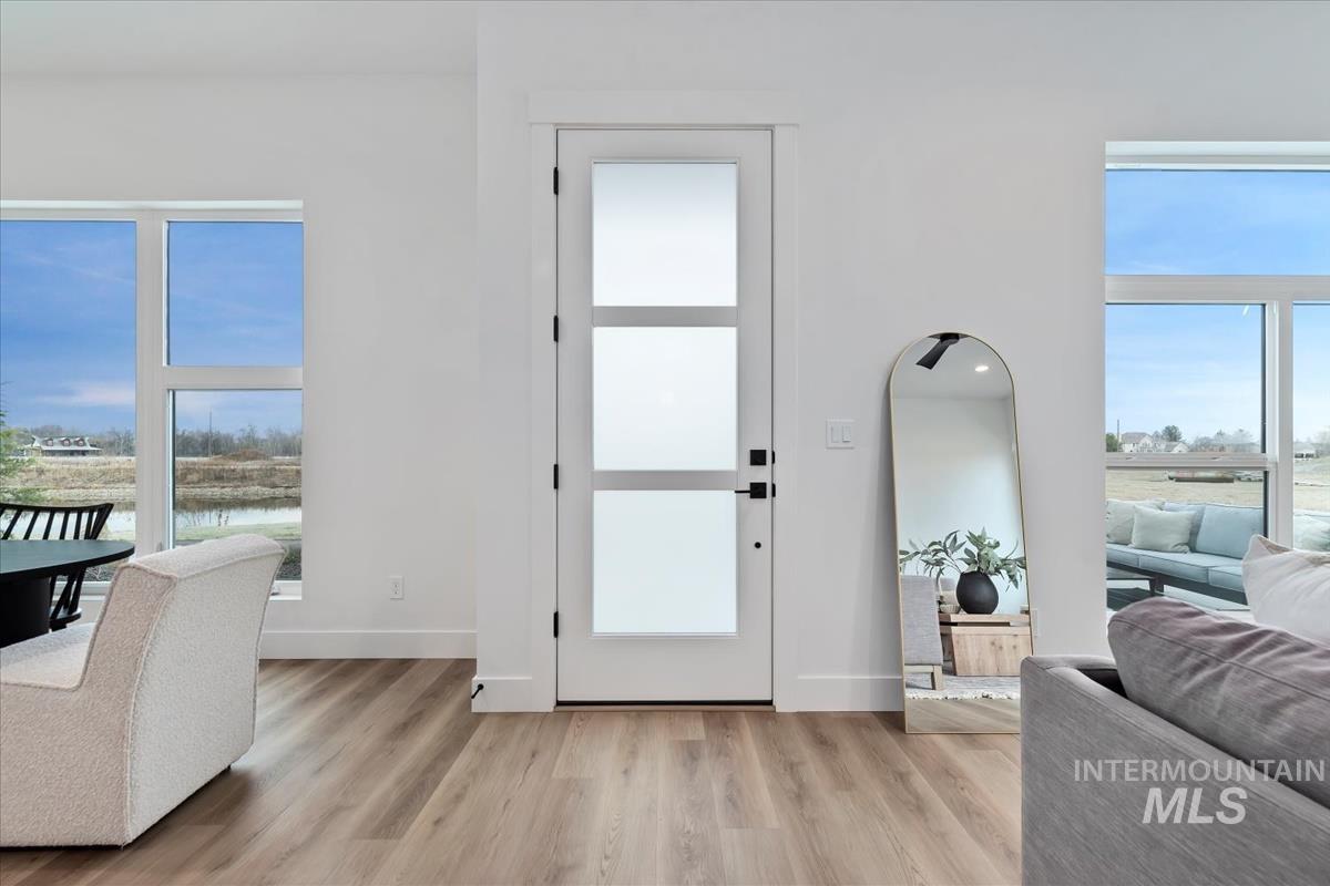 Entryway featuring plenty of natural light and light wood-style floors
