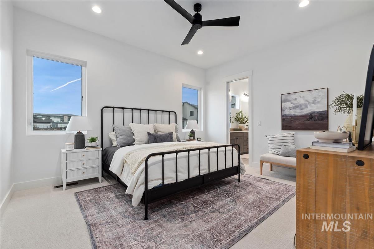 Bedroom featuring ceiling fan, light carpet, connected bathroom, and recessed lighting