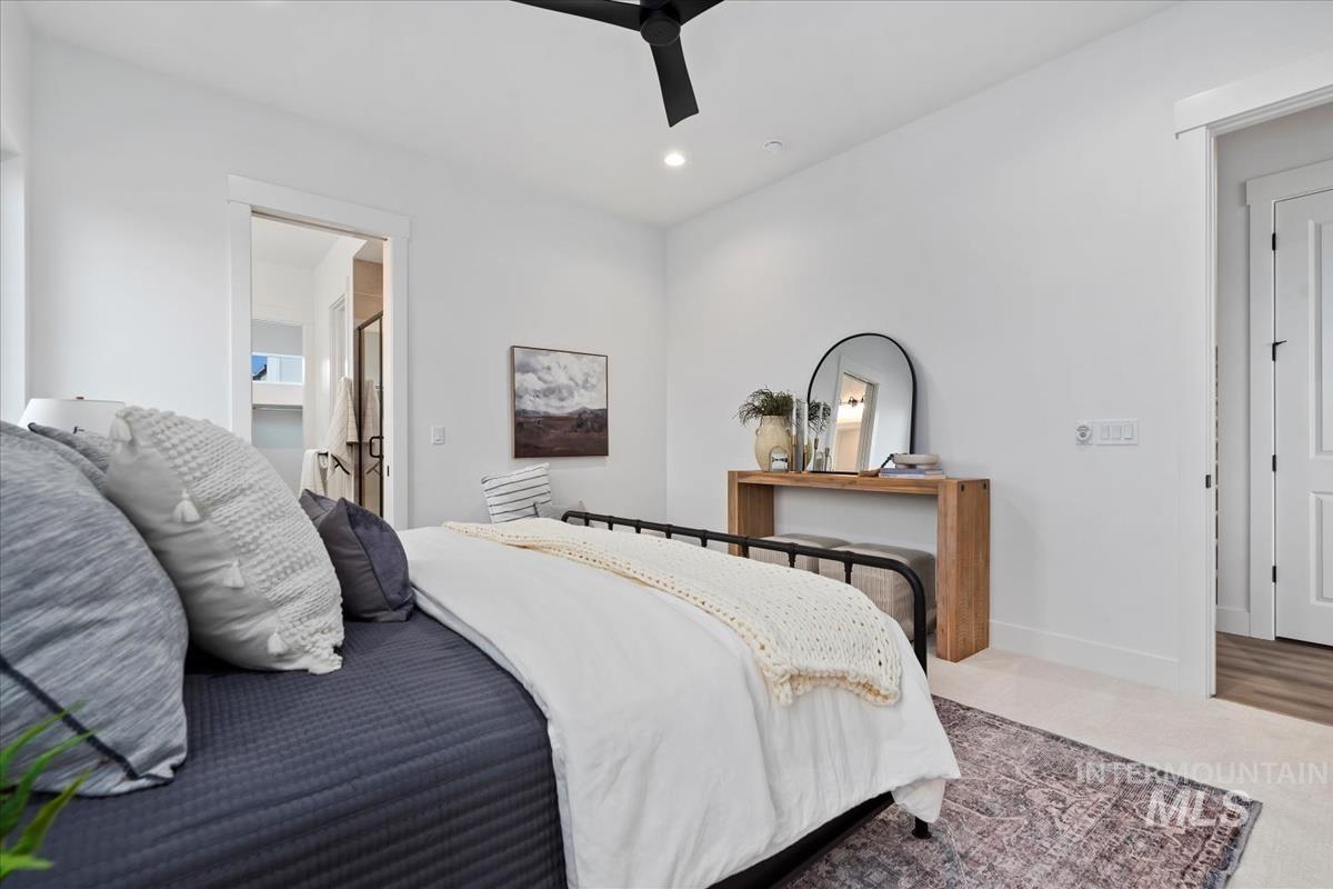 Bedroom with a ceiling fan, recessed lighting, and ensuite bathroom