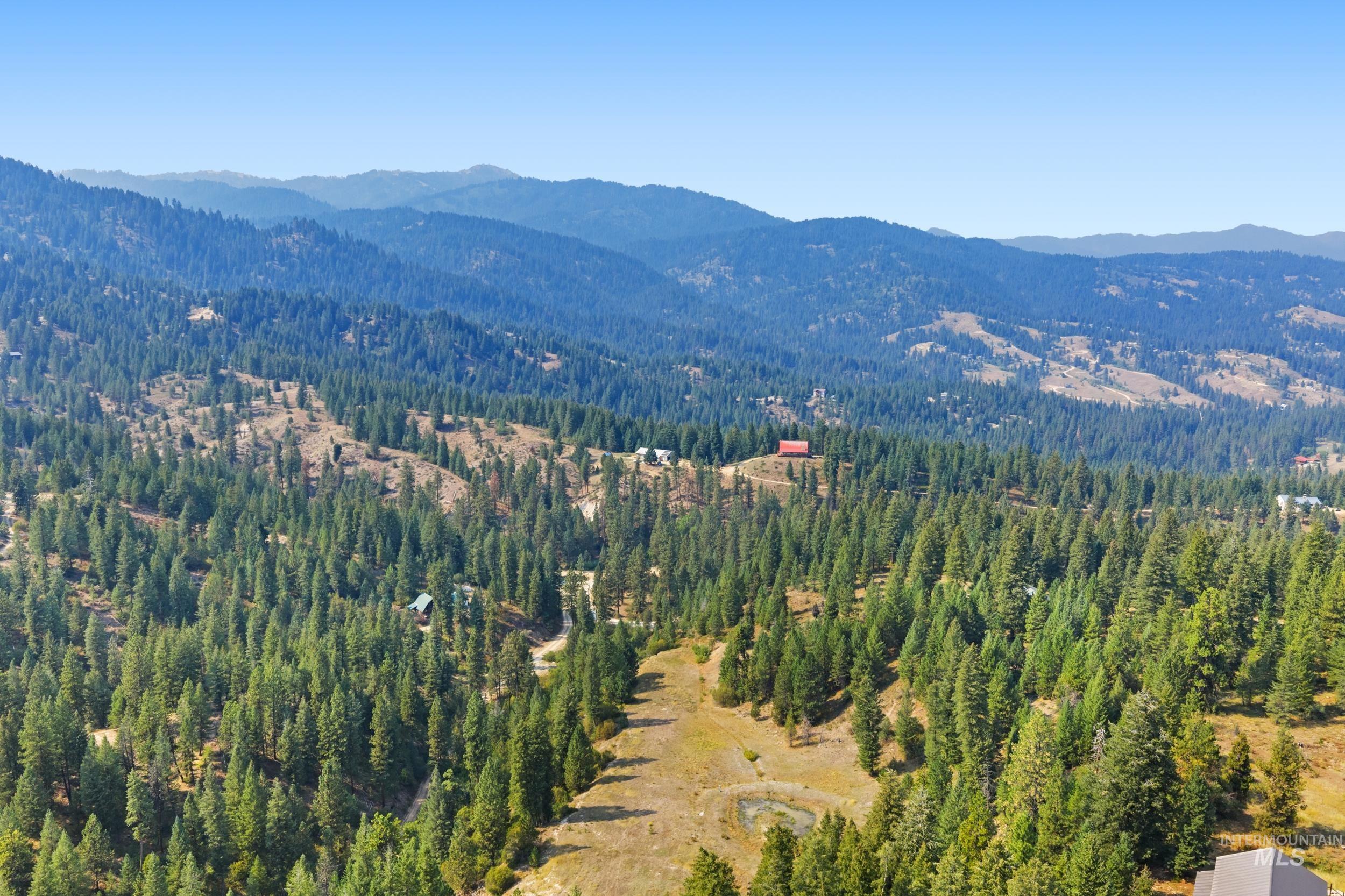 Aerial view of property and surrounding area with mountains