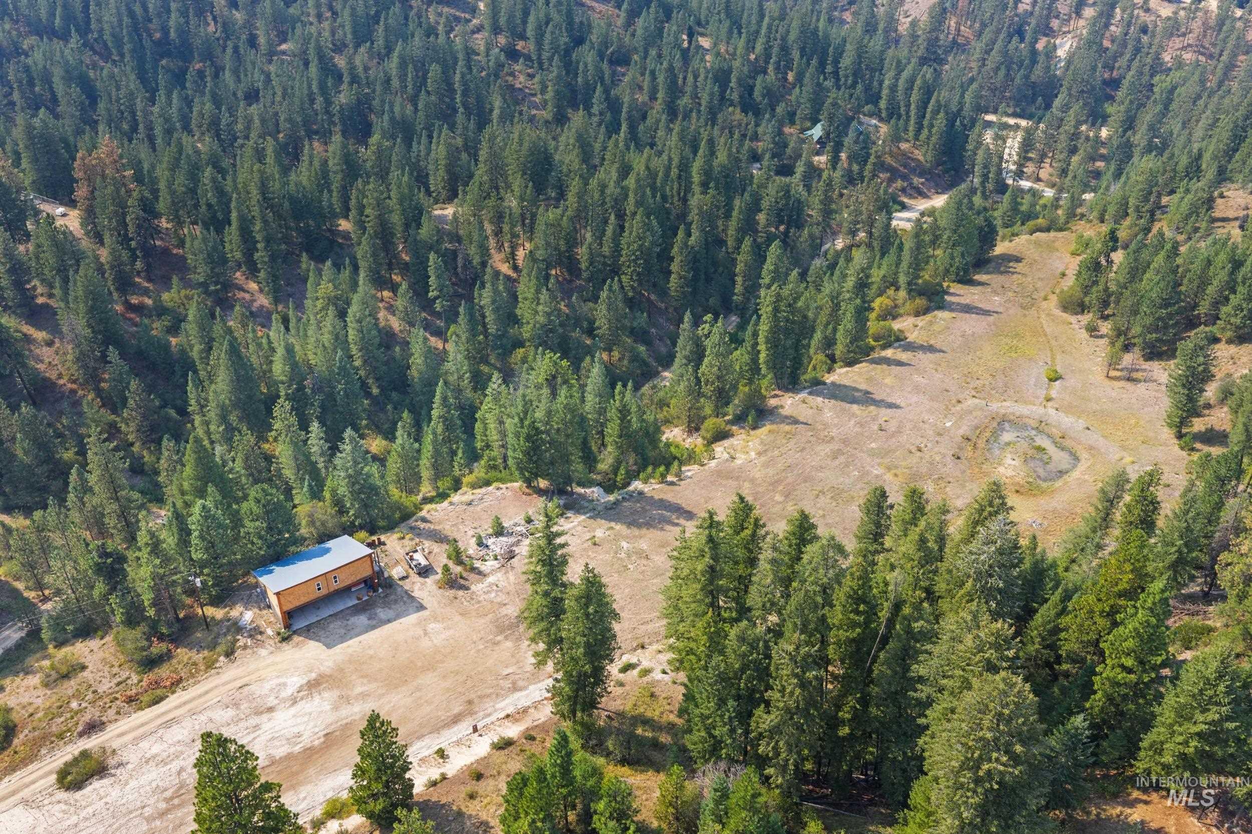 Aerial overview of property's location featuring a heavily wooded area