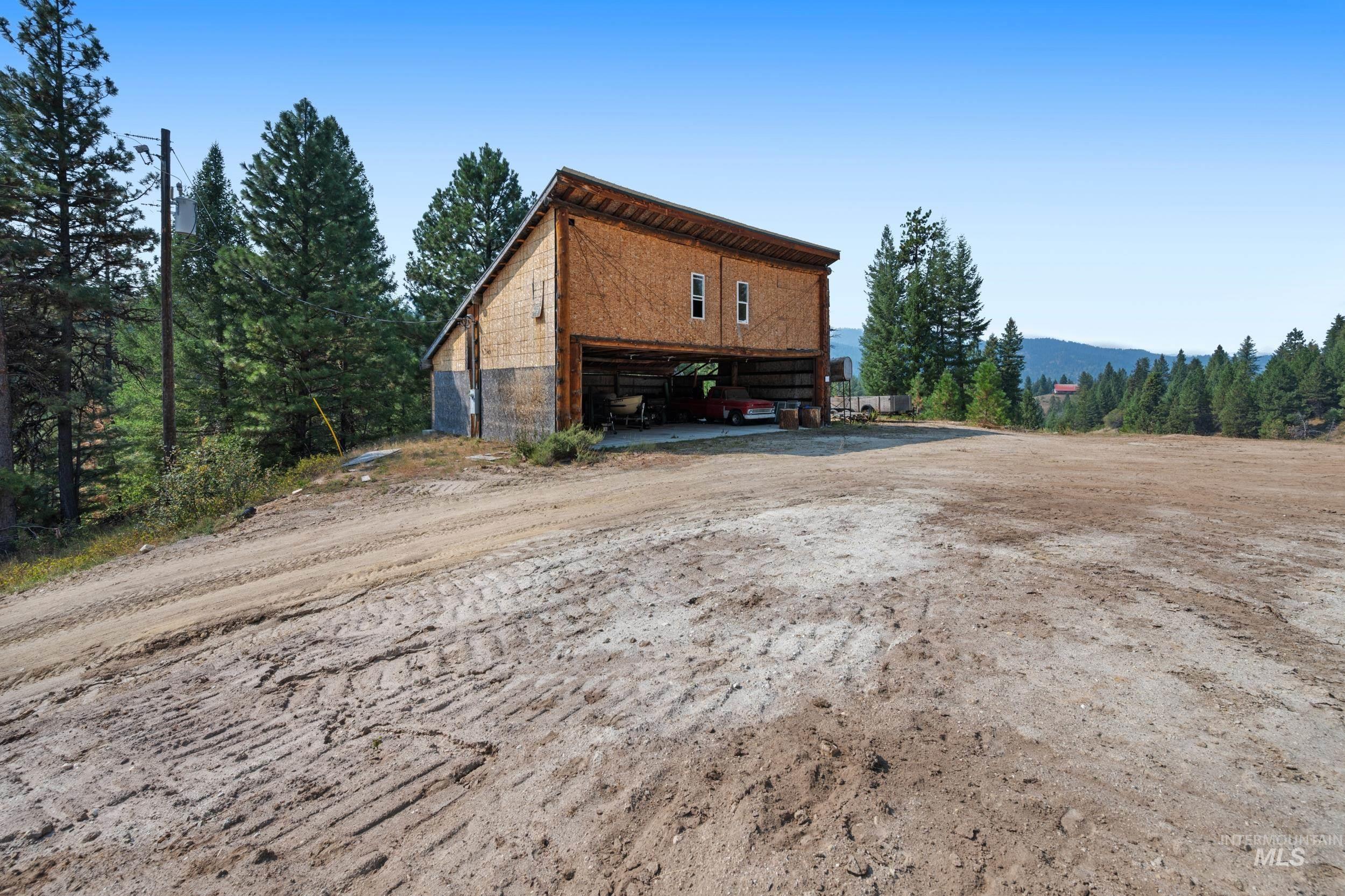 View of property exterior featuring an outdoor structure and driveway