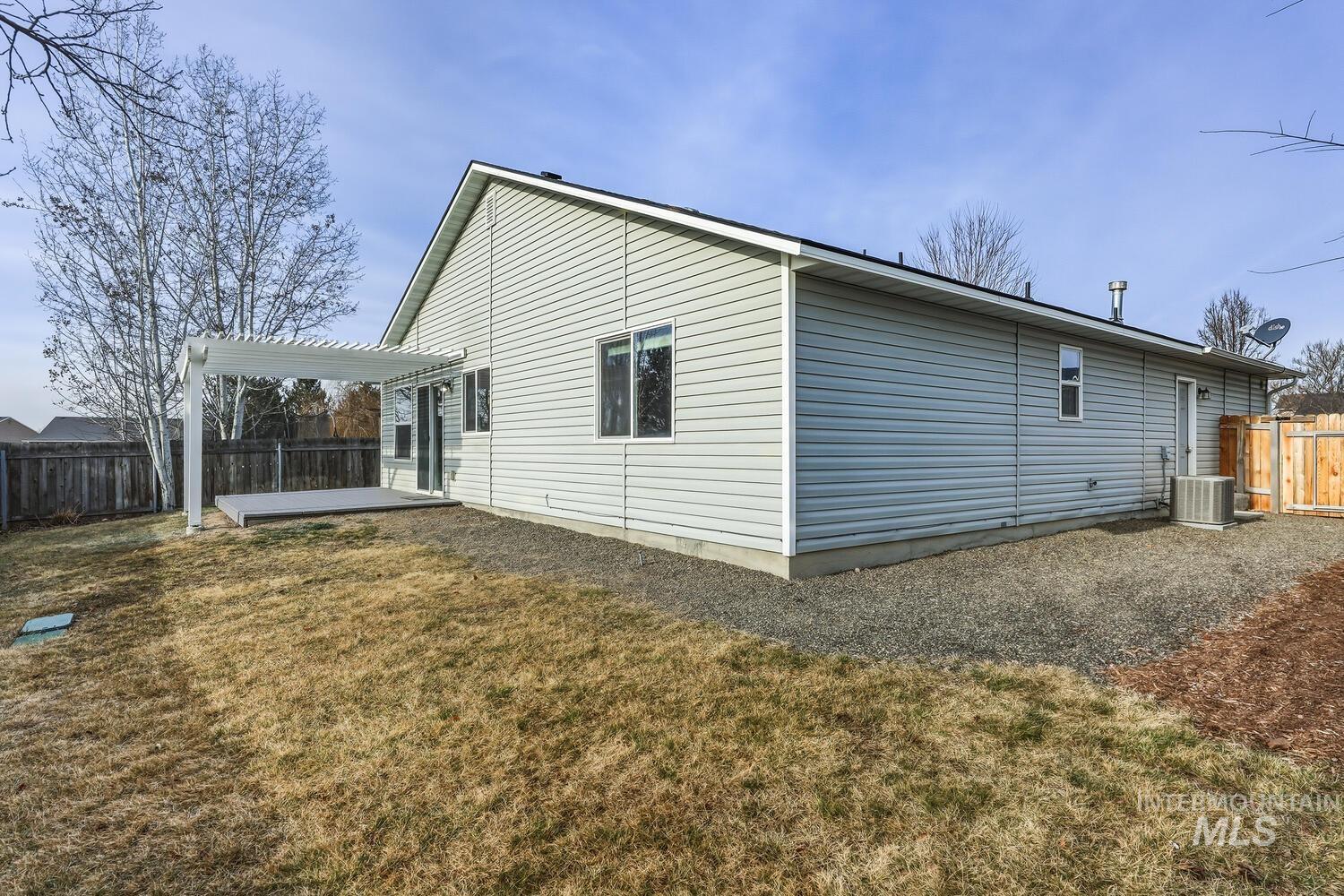 Rear view of property with a fenced backyard, a patio, and a pergola