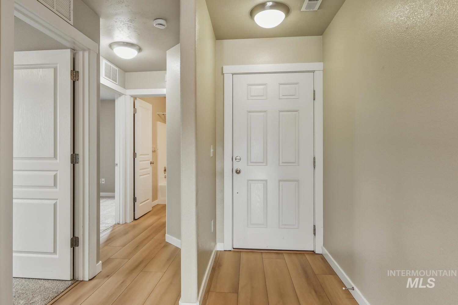 Entryway with baseboards and wood finished floors