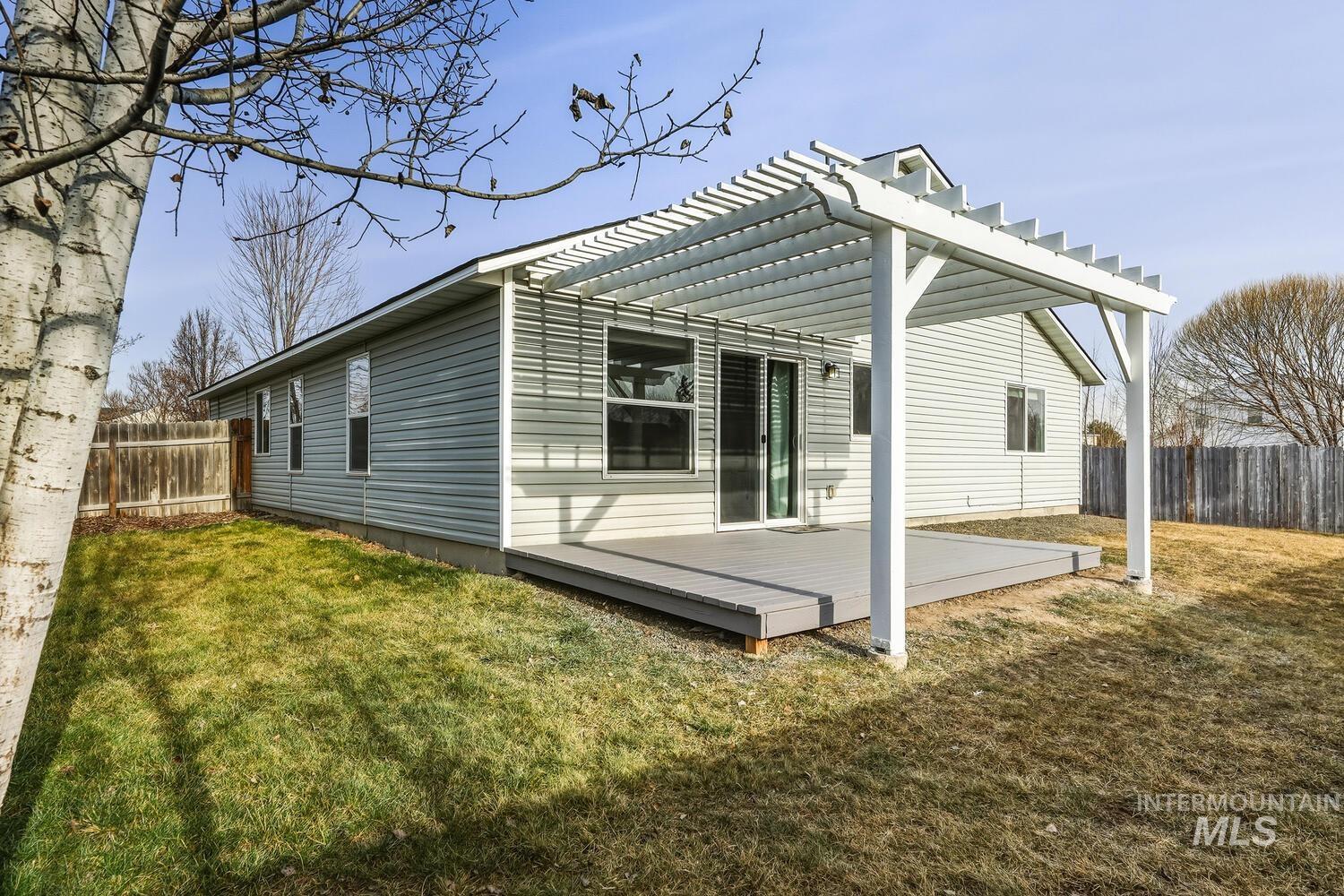 View of side of property with a wooden deck