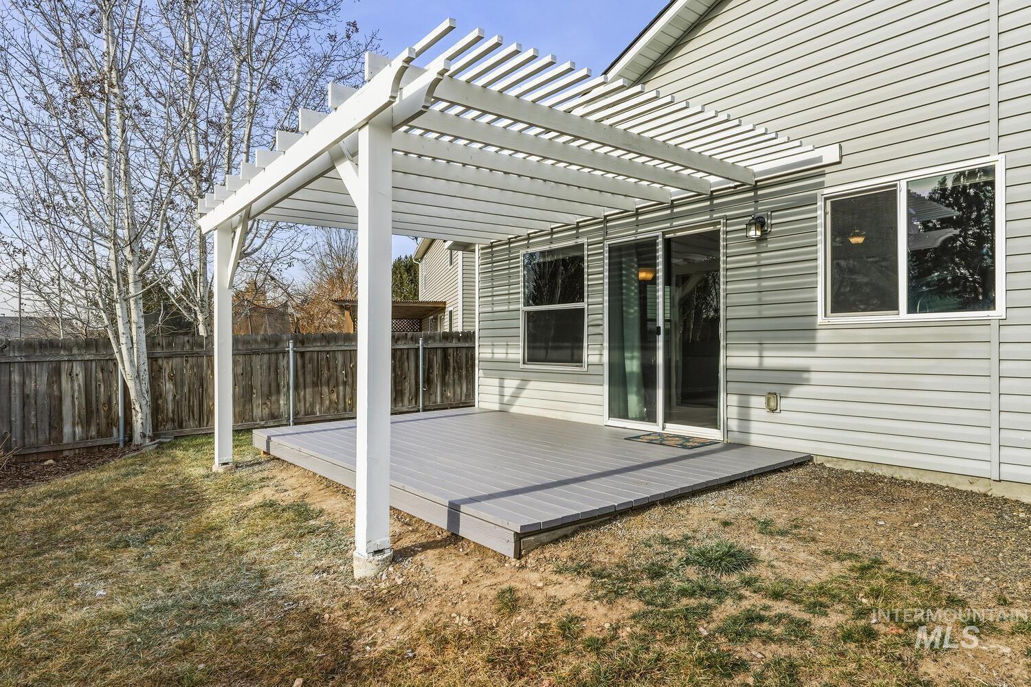 Fenced backyard featuring a wooden deck