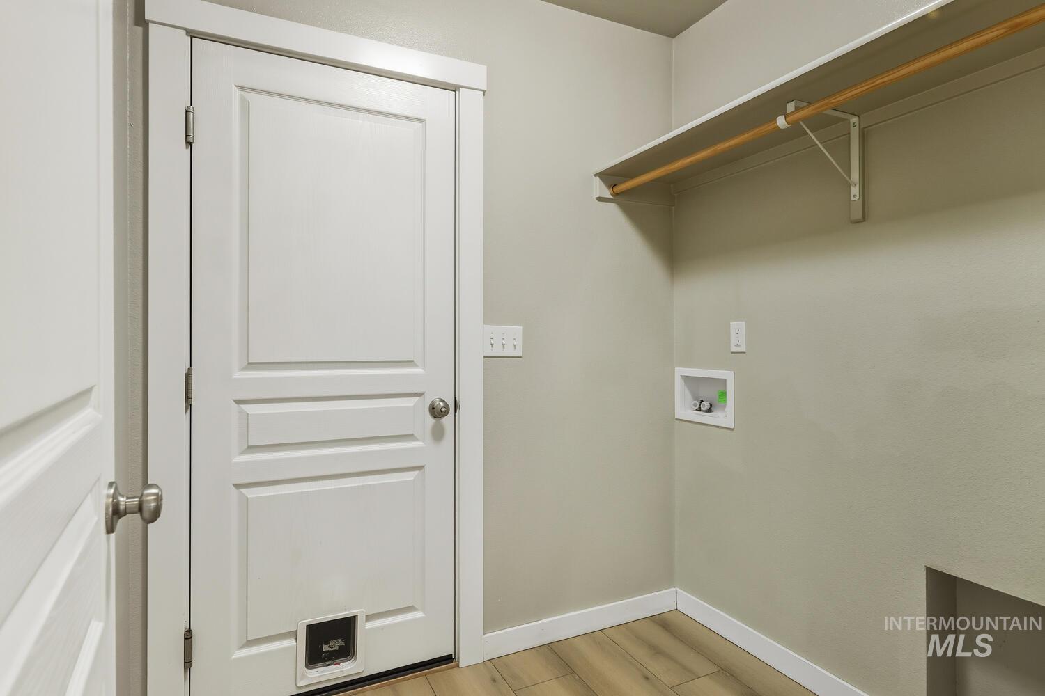 Washroom featuring washer hookup and light wood-style flooring