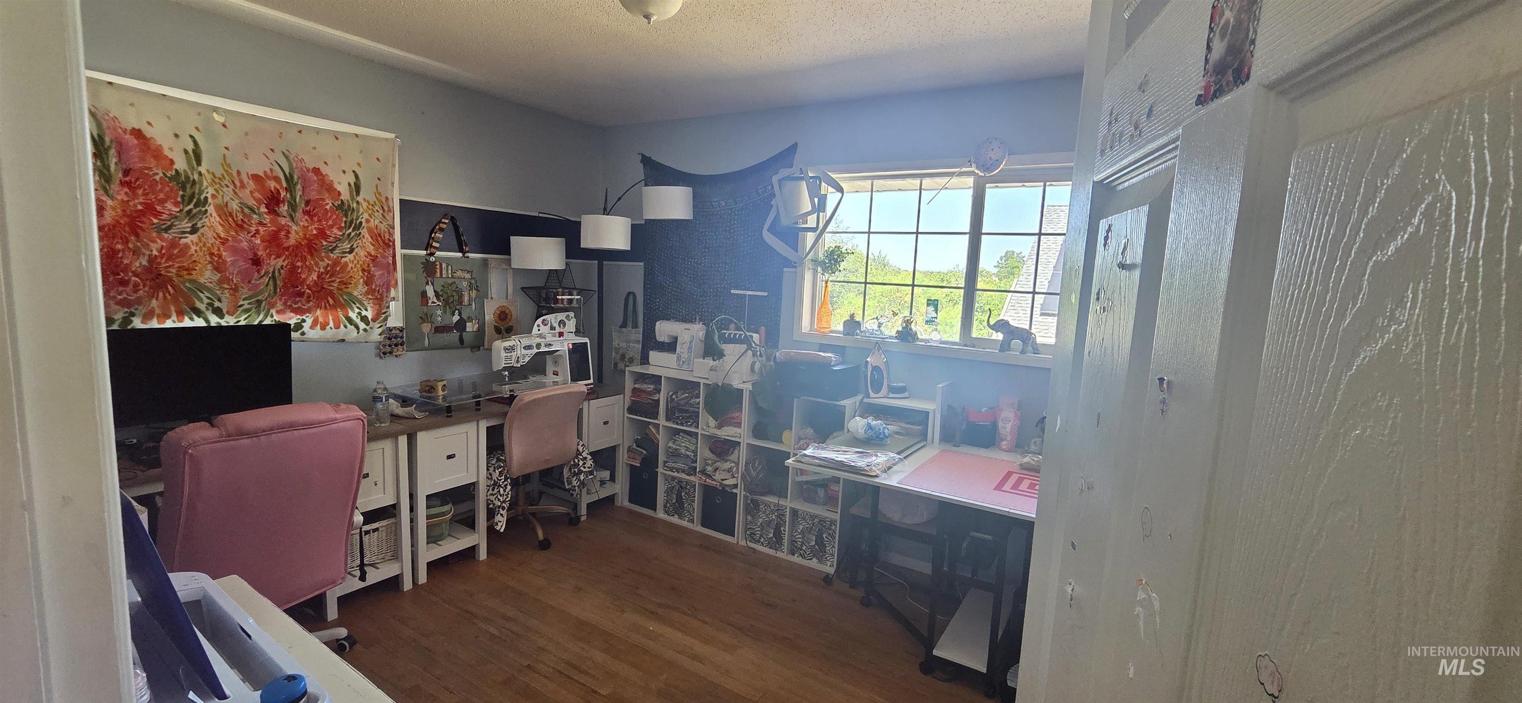 Home office with wood finished floors