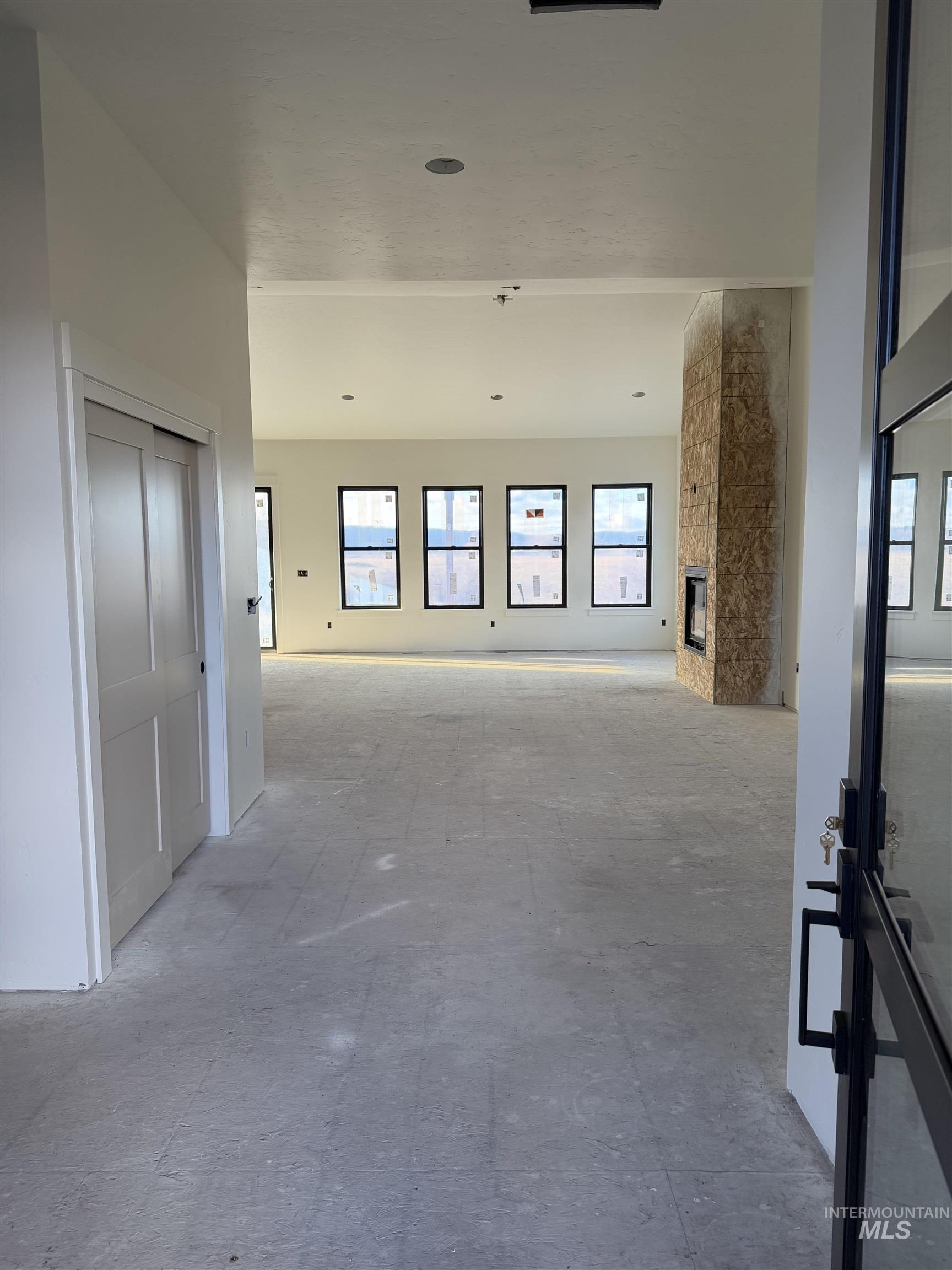 Spare room featuring a stone fireplace