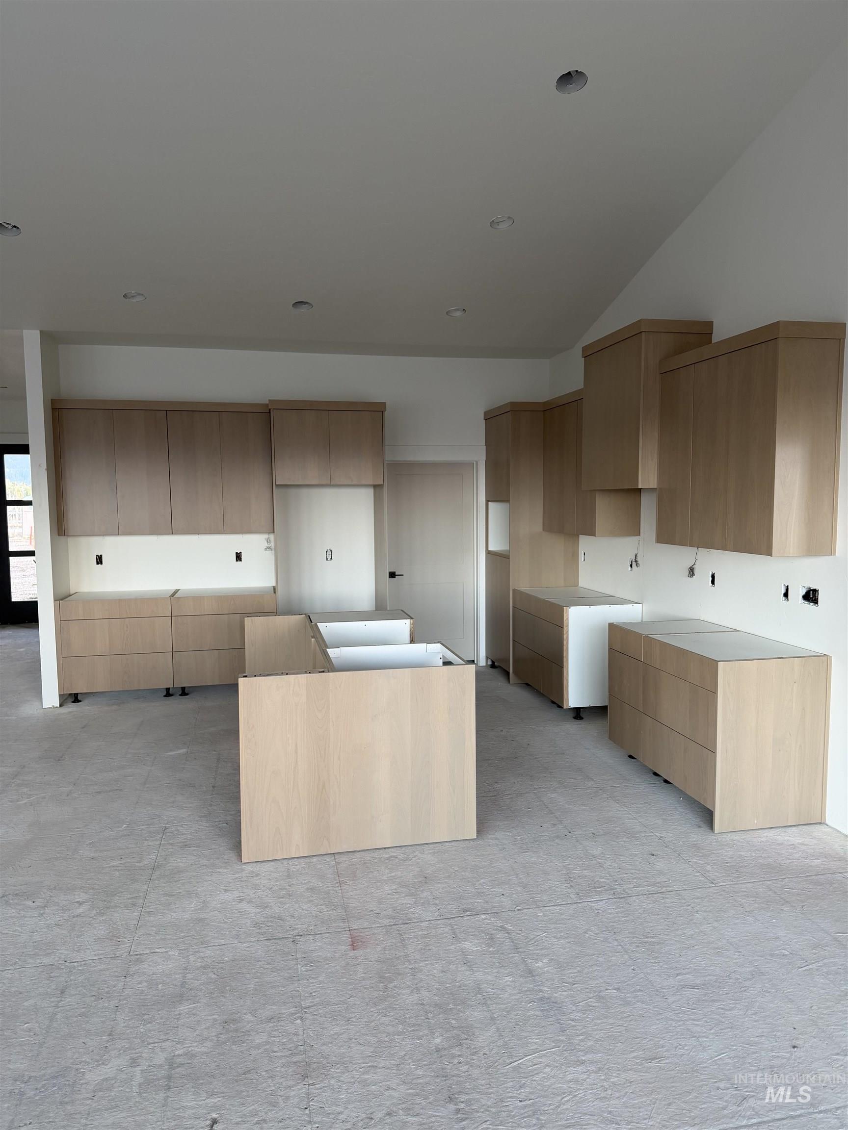 Kitchen featuring modern cabinets, light brown cabinets, and a center island