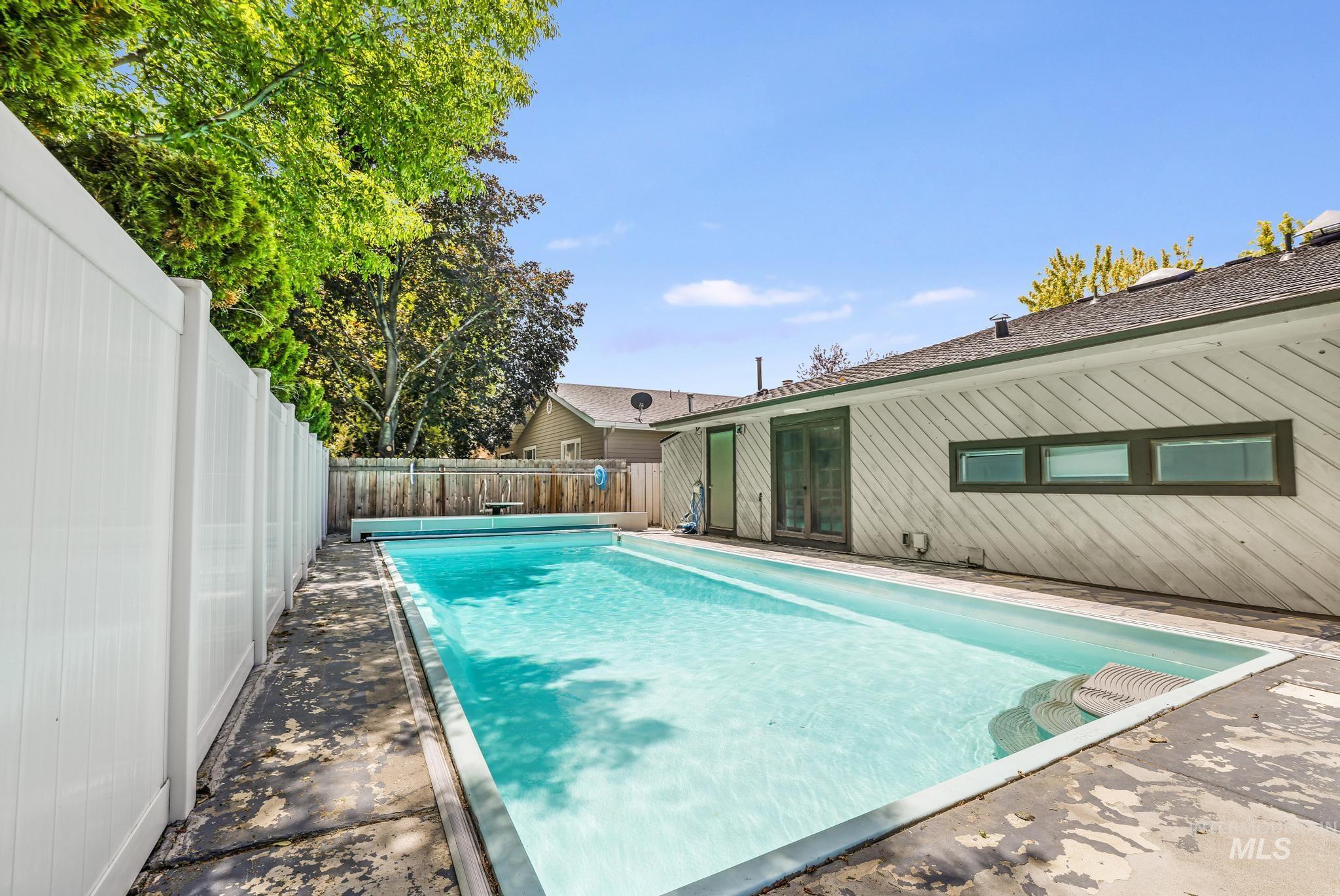 View of pool featuring a fenced backyard and french doors