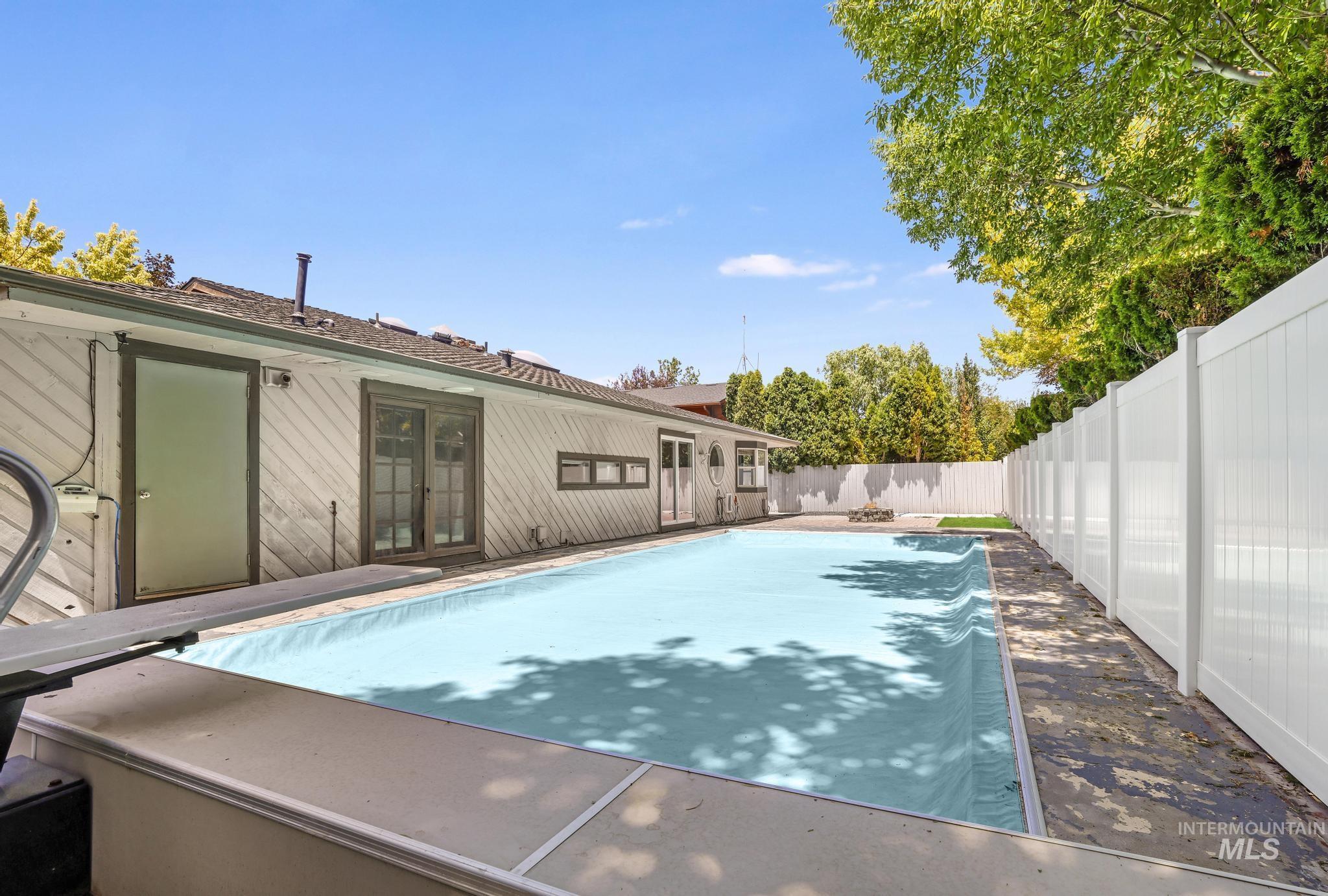 View of swimming pool with a fenced backyard and french doors