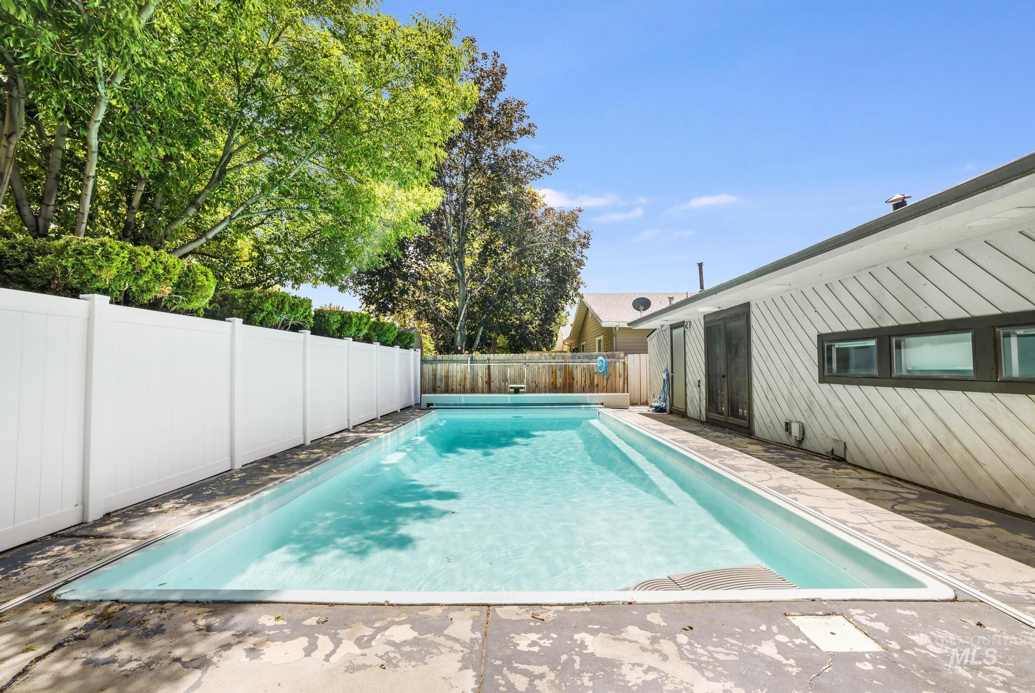 View of swimming pool with a fenced backyard