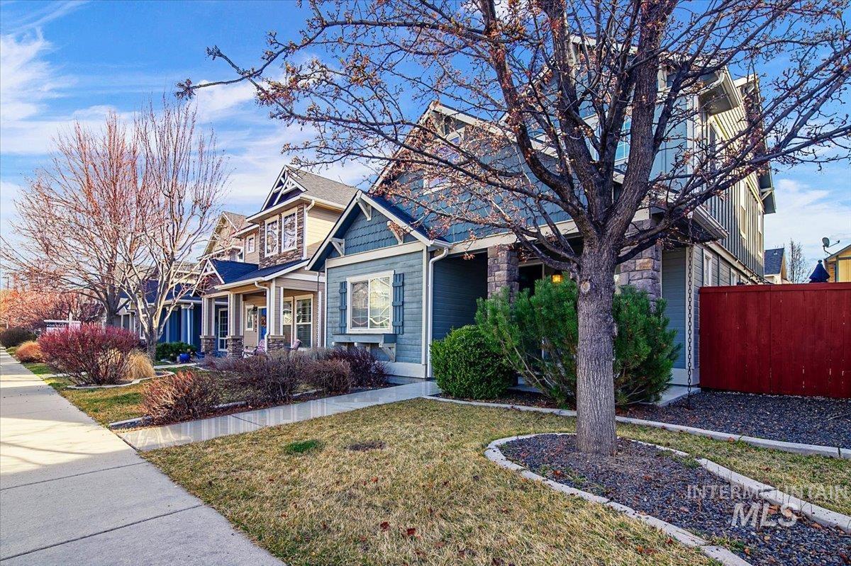 Craftsman-style house featuring stone siding and covered porch