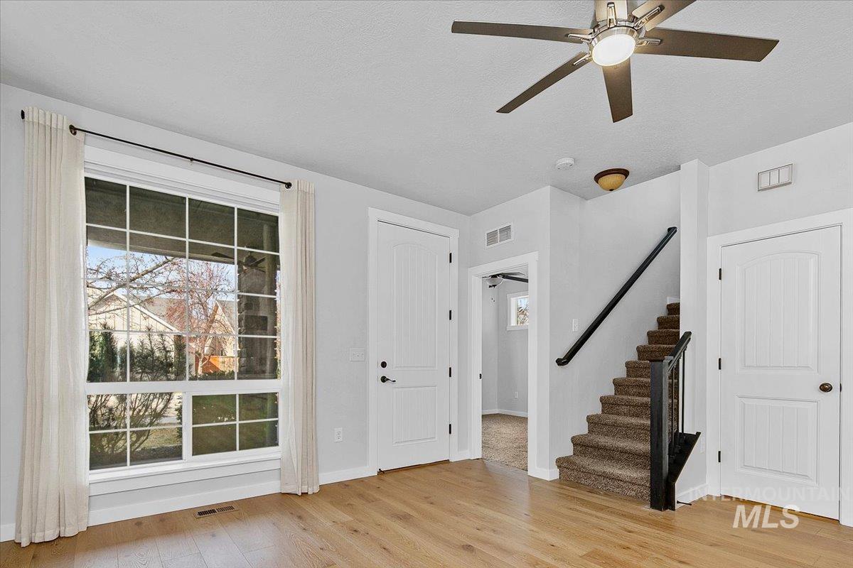 Entrance foyer featuring light wood-style flooring and ceiling fan