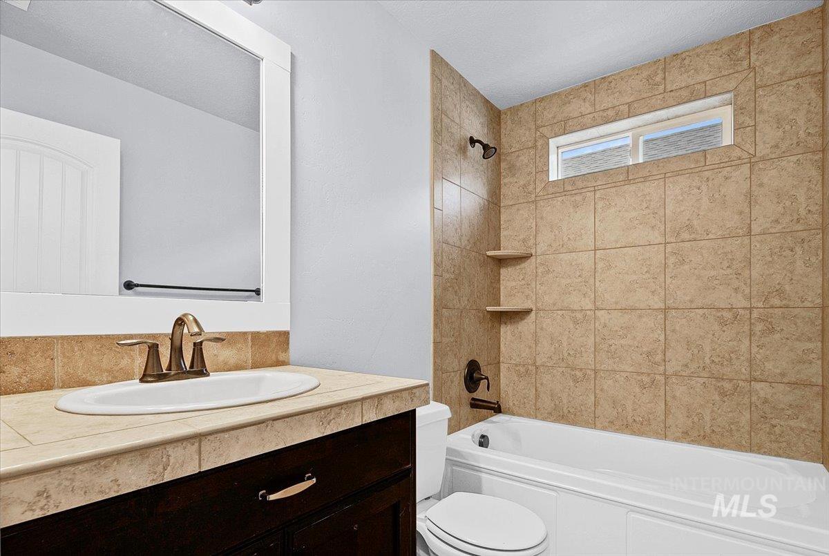 Bathroom featuring vanity and bathing tub / shower combination