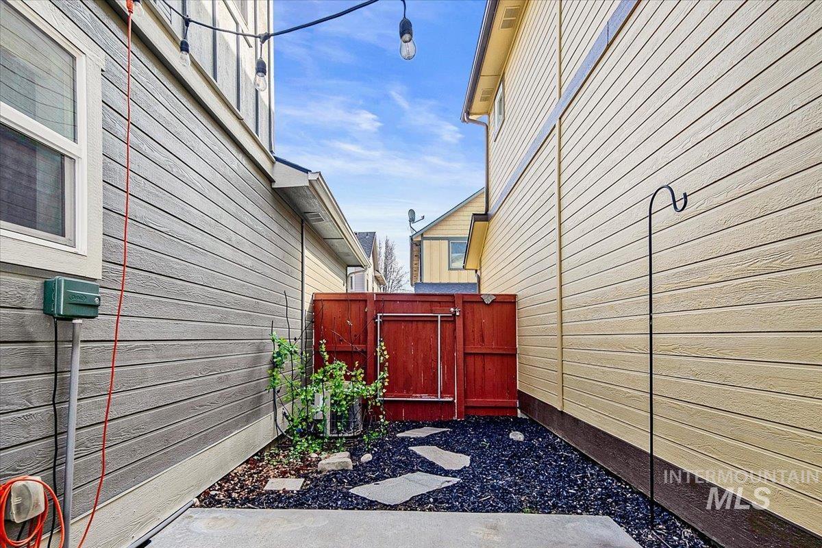 View of side of property with a gate