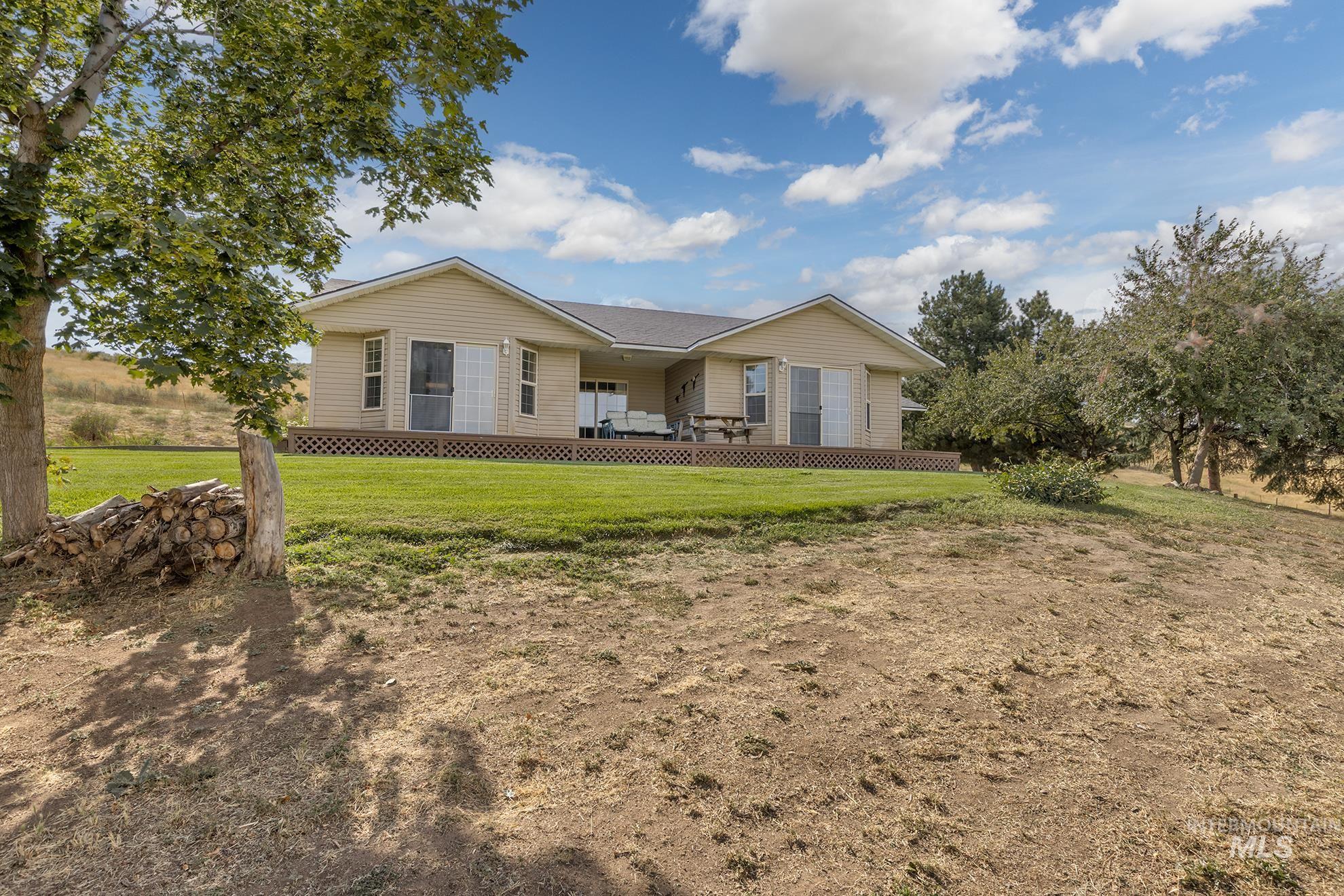 Rear view of property with a lawn