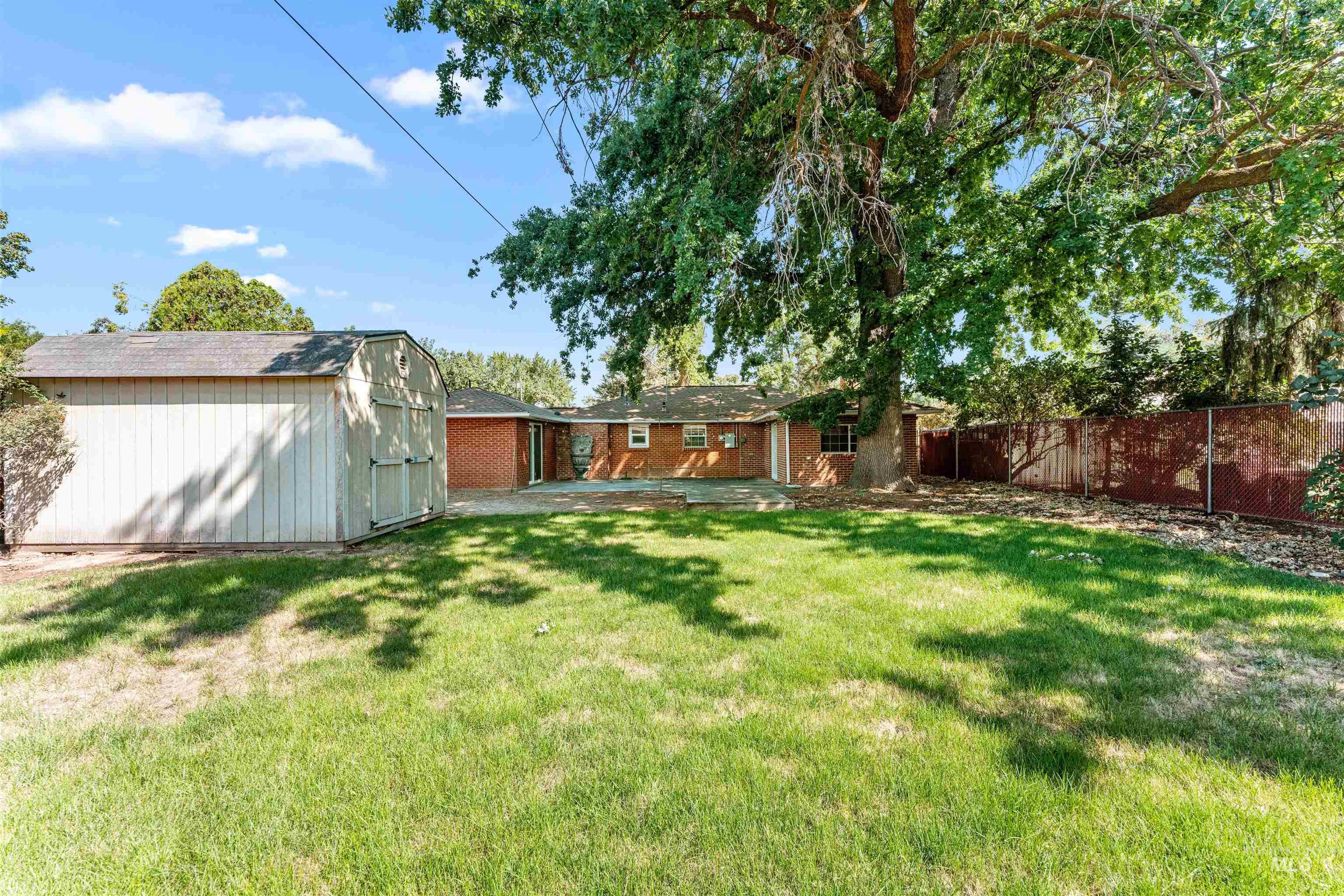 View of yard featuring a patio area and a storage unit