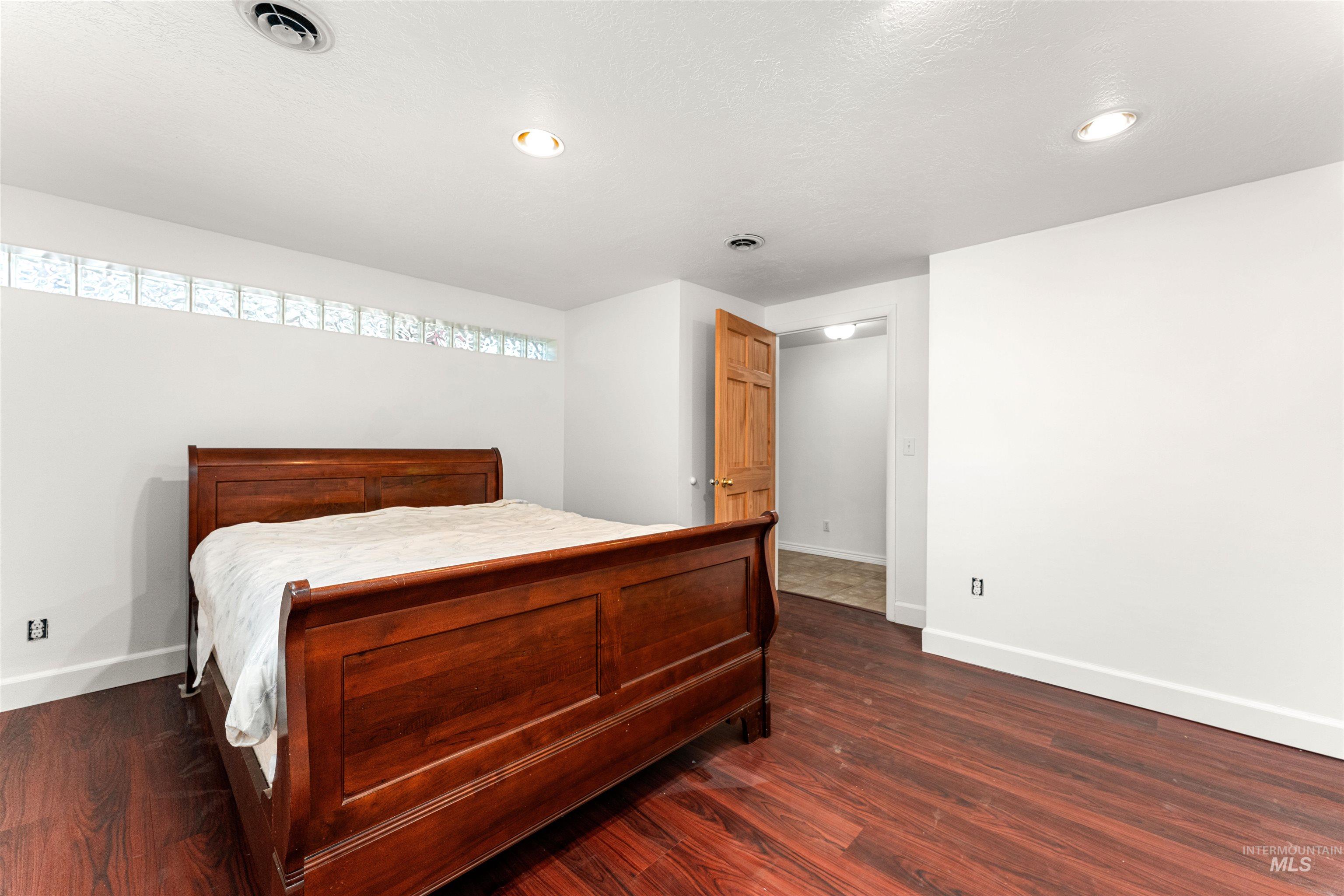 Bedroom featuring dark wood finished floors and recessed lighting