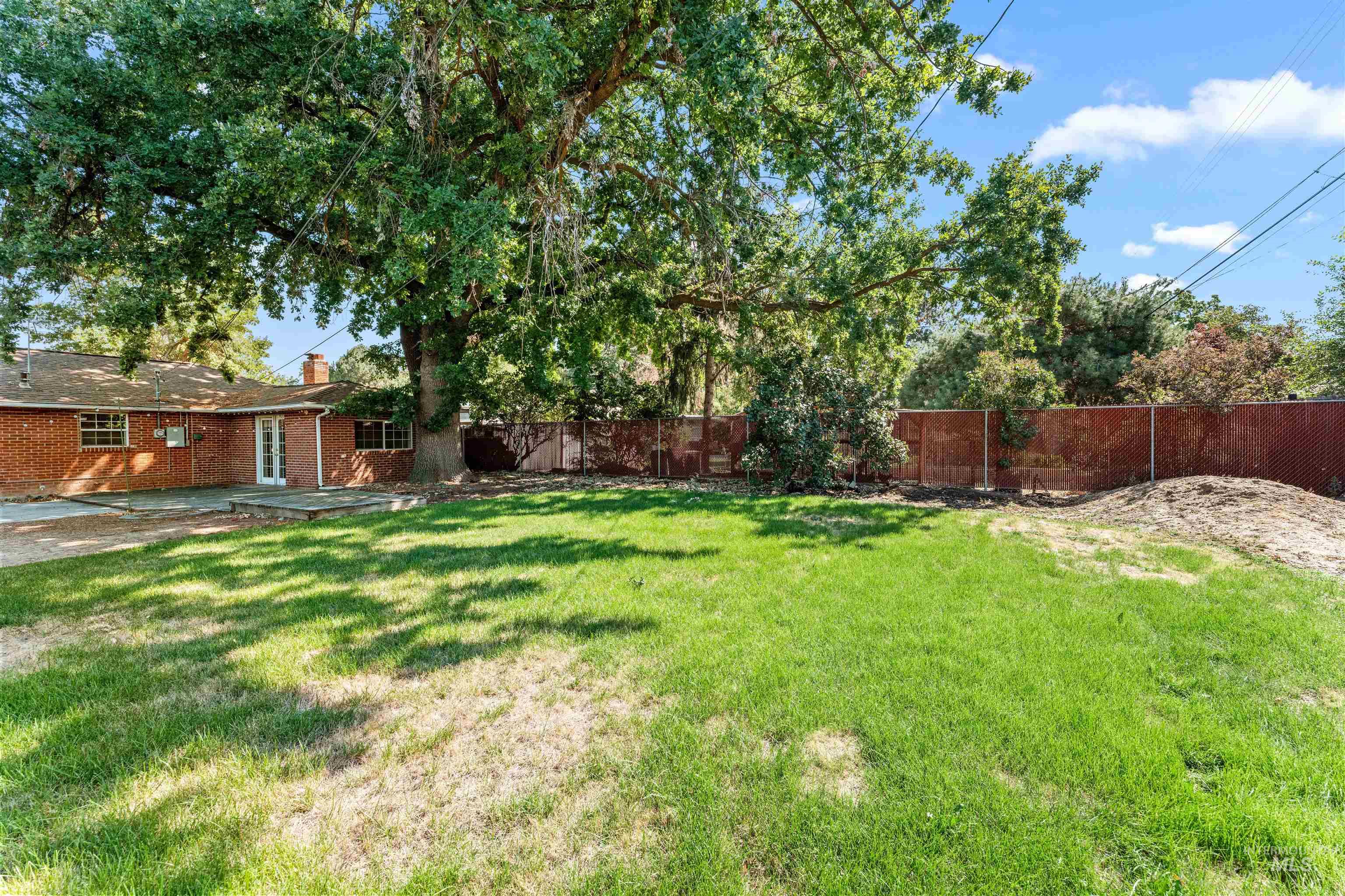 Fenced backyard featuring a patio