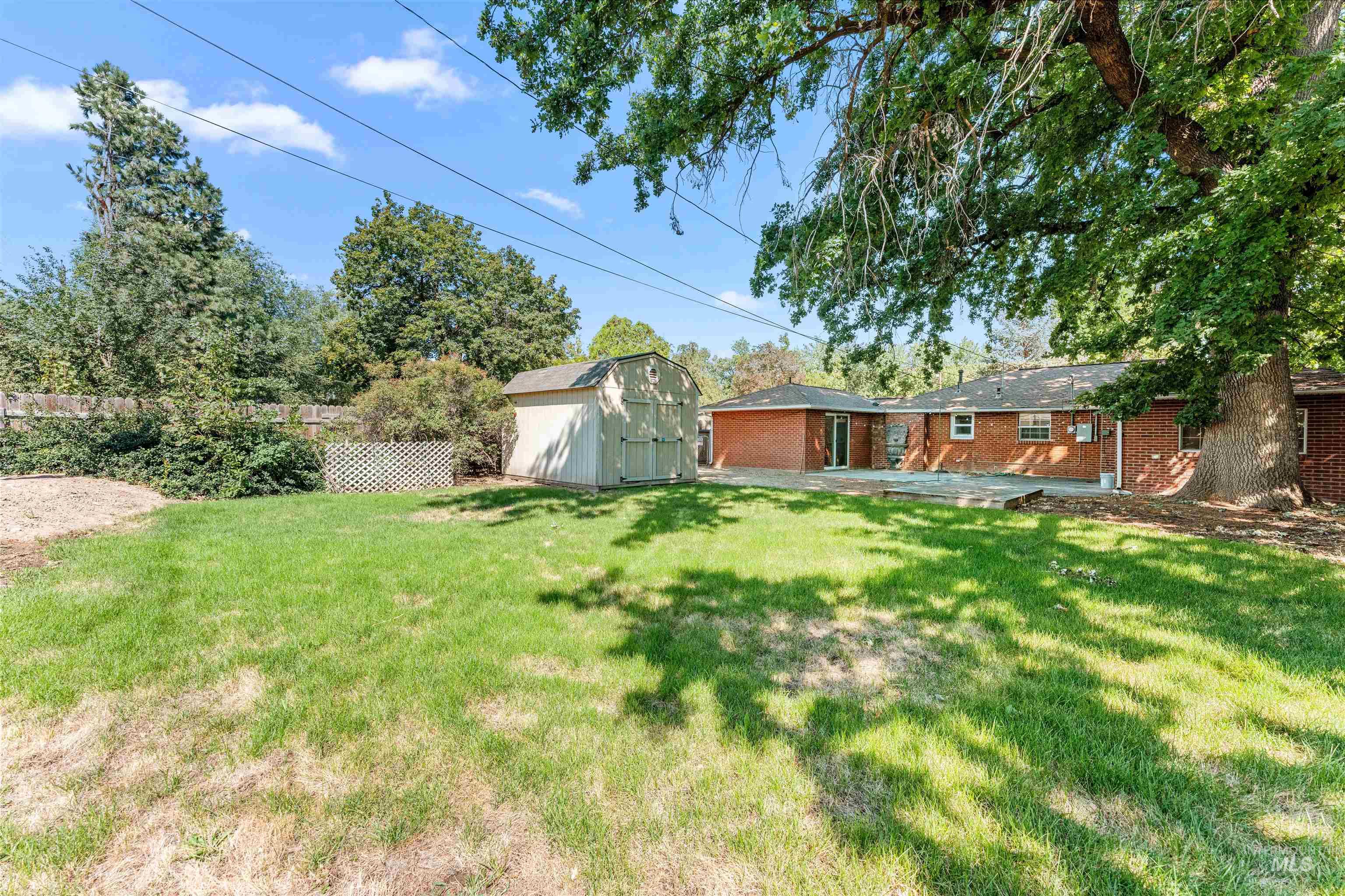 View of yard featuring a shed and a patio