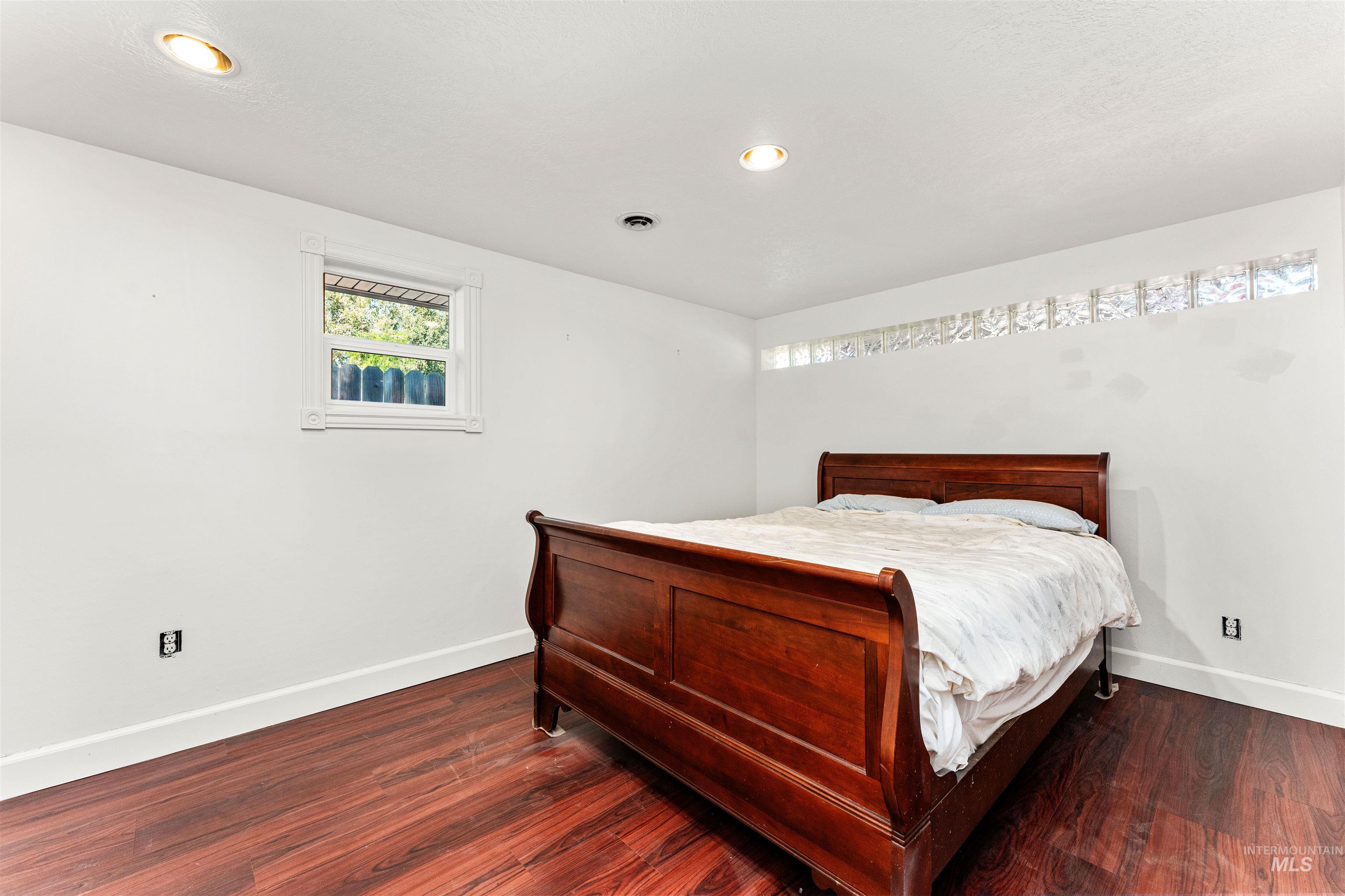 Bedroom featuring dark wood-style floors and recessed lighting