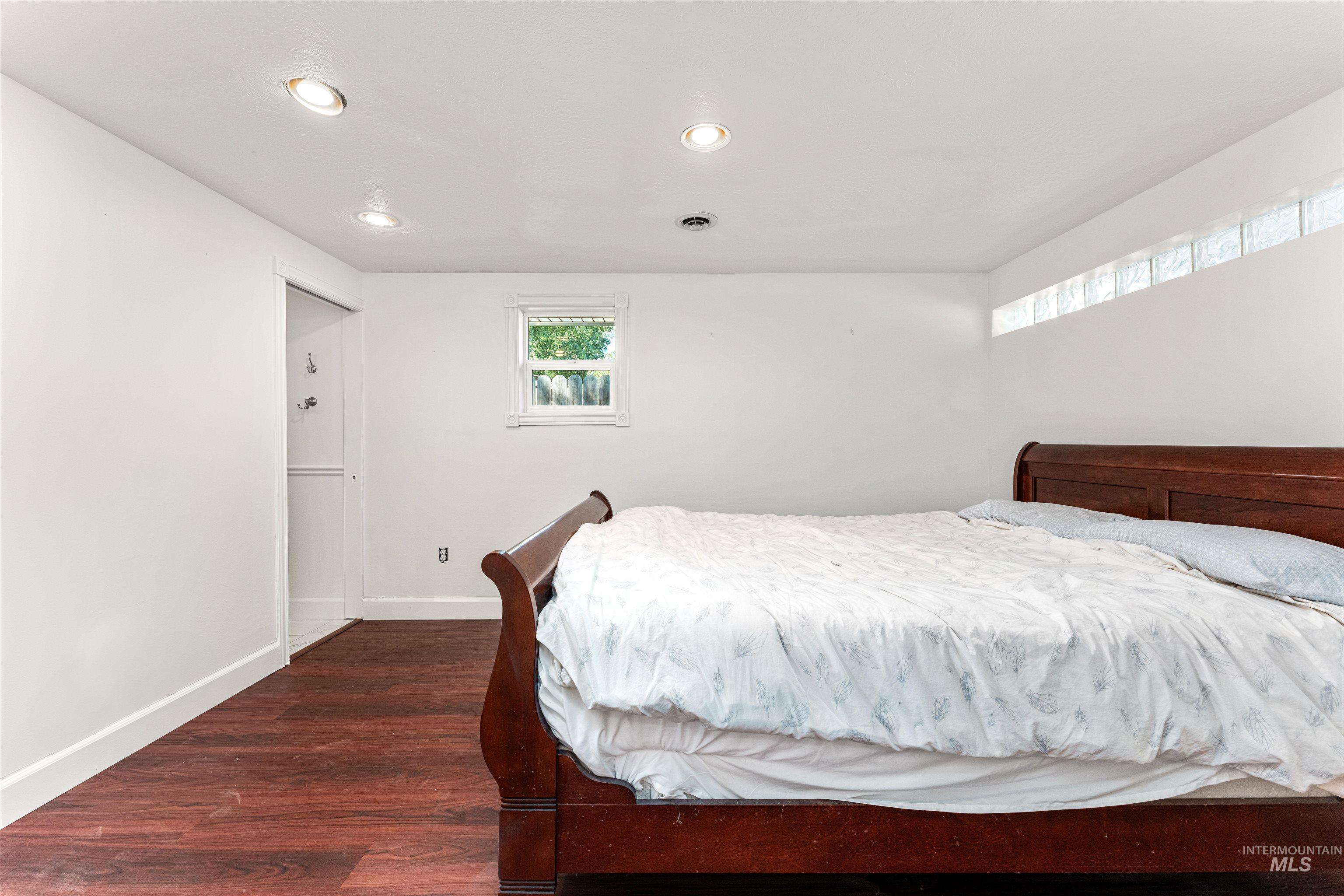 Bedroom featuring dark wood-type flooring and recessed lighting