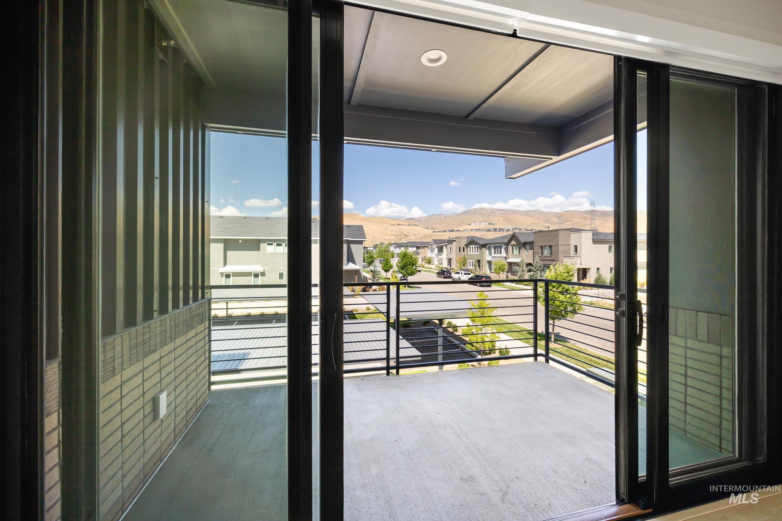 Balcony featuring a residential view and a mountain view