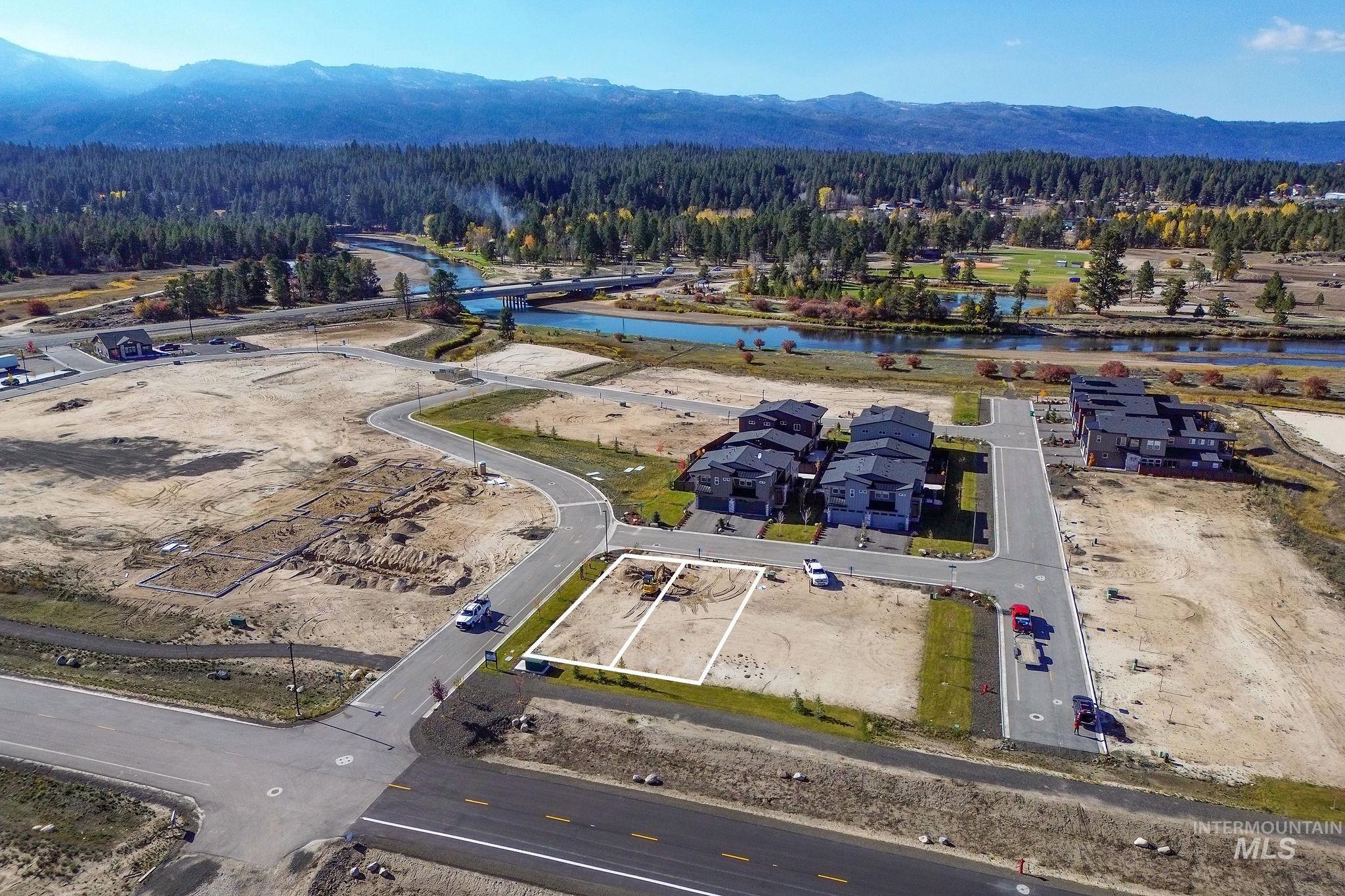Drone / aerial view of a water and mountain view and a heavily wooded area