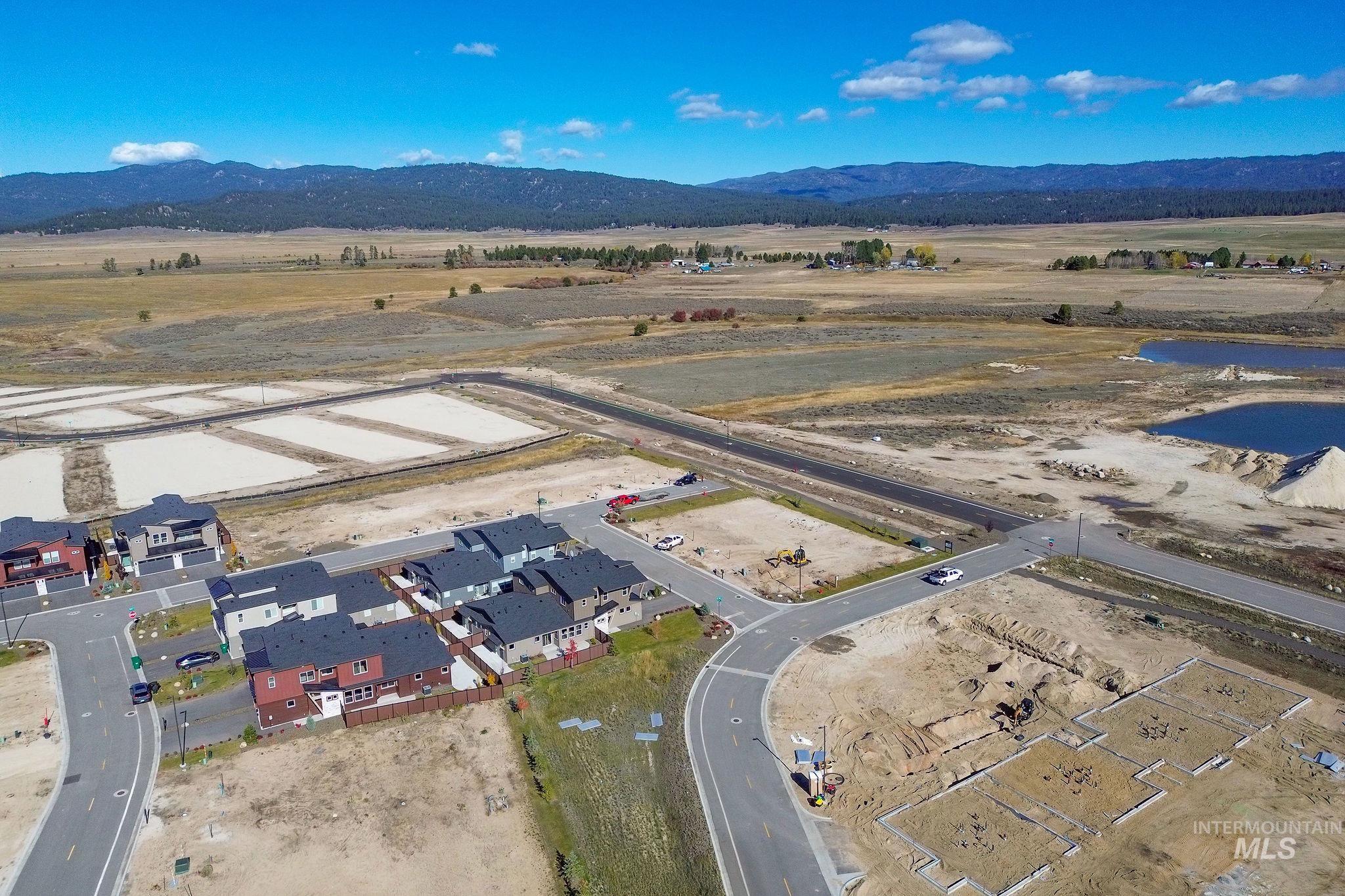 Aerial overview of property's location with a mountain backdrop and rural landscape
