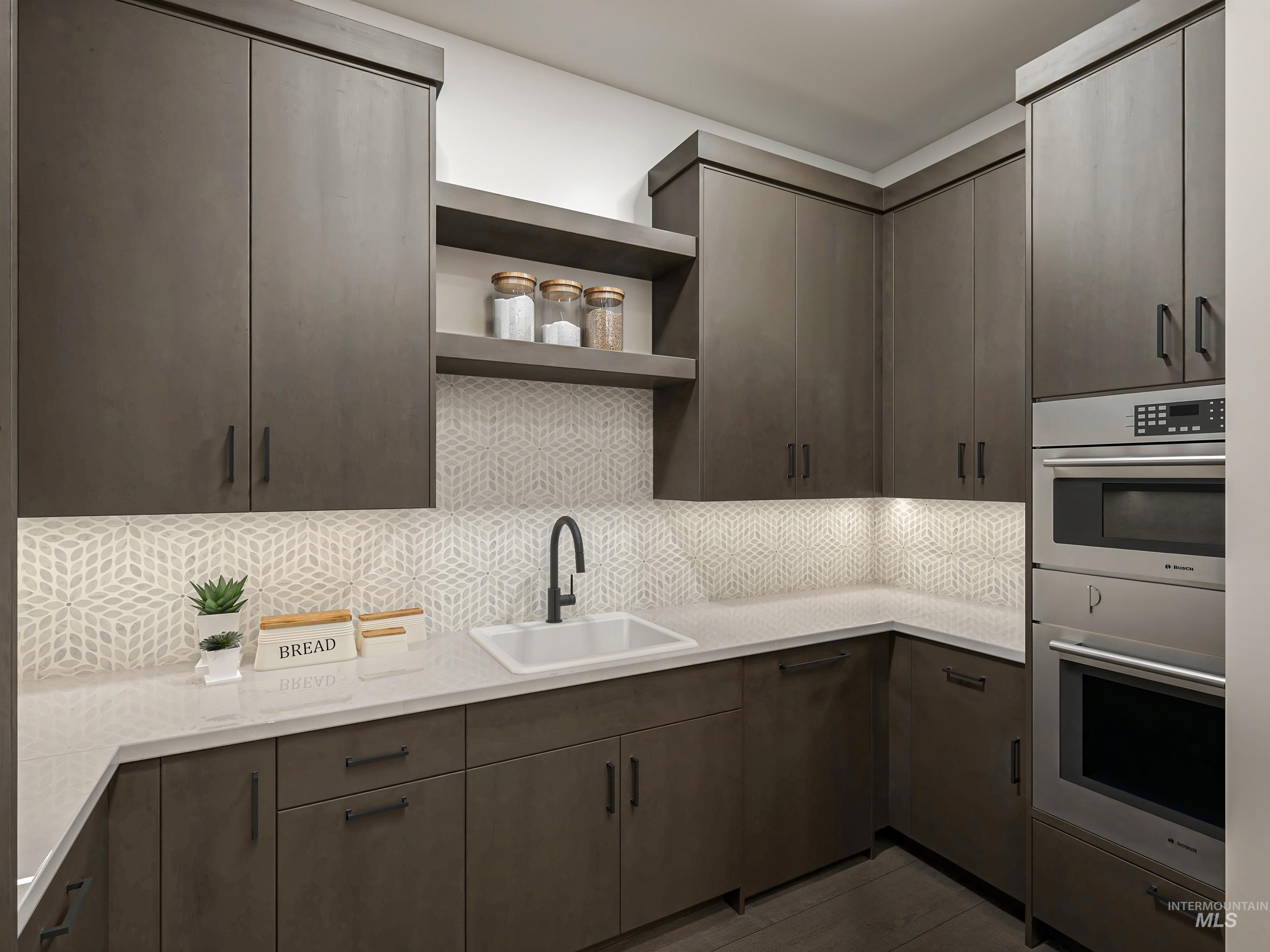 Digital Rendering. Modern kitchen featuring dark wood-finish cabinetry, light-toned countertops, geometric backsplash tiling, and integrated stainless steel appliances