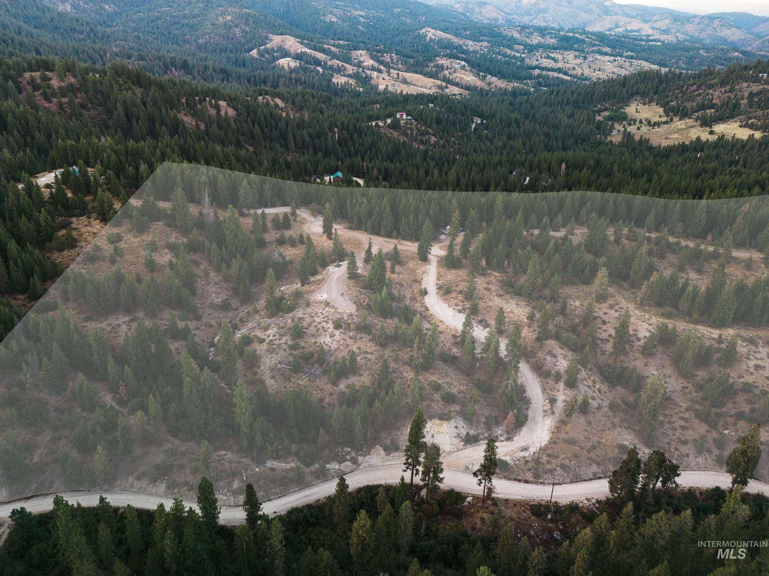 View of property location with a heavily wooded area