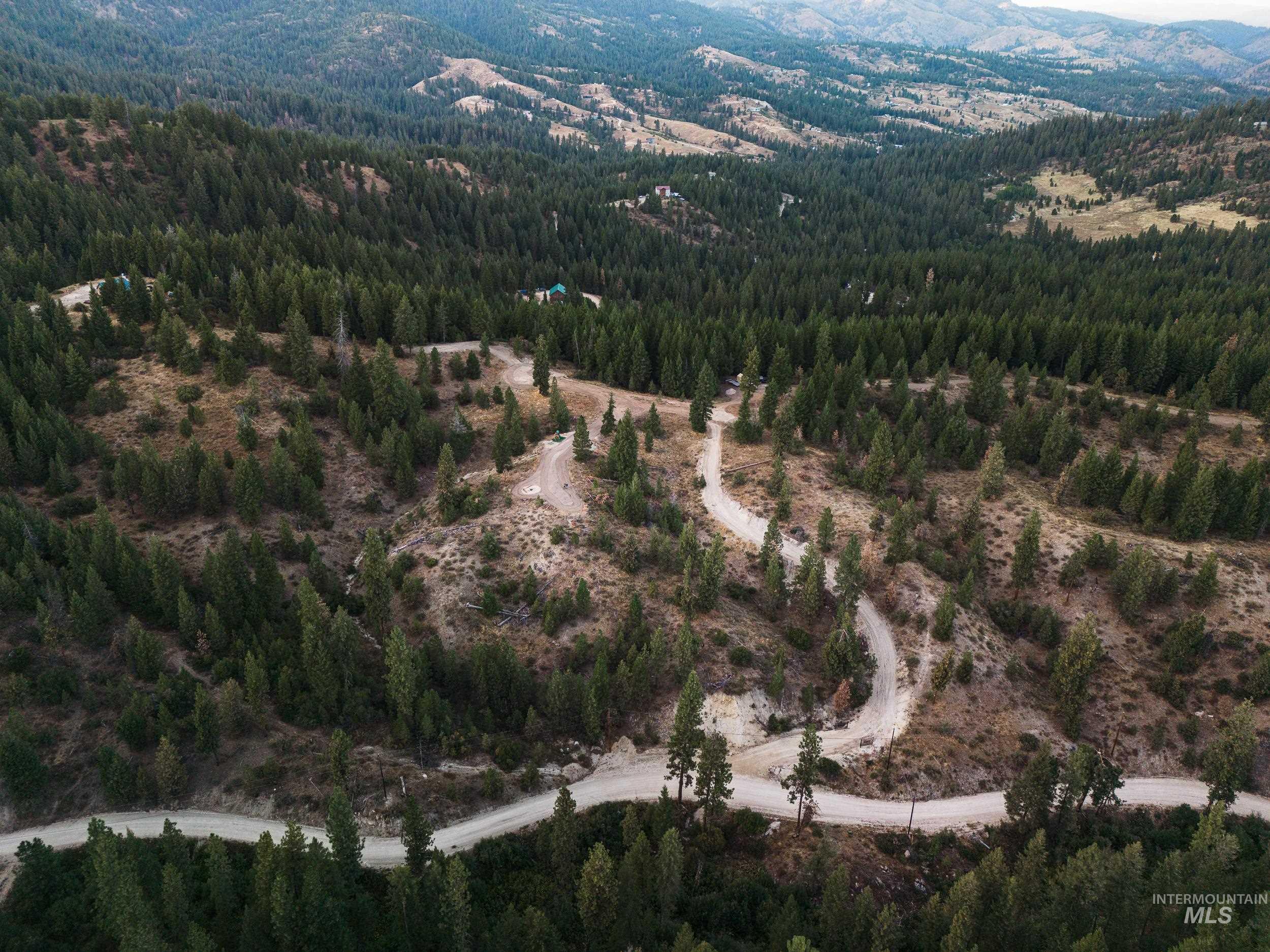 Aerial overview of property's location featuring a heavily wooded area